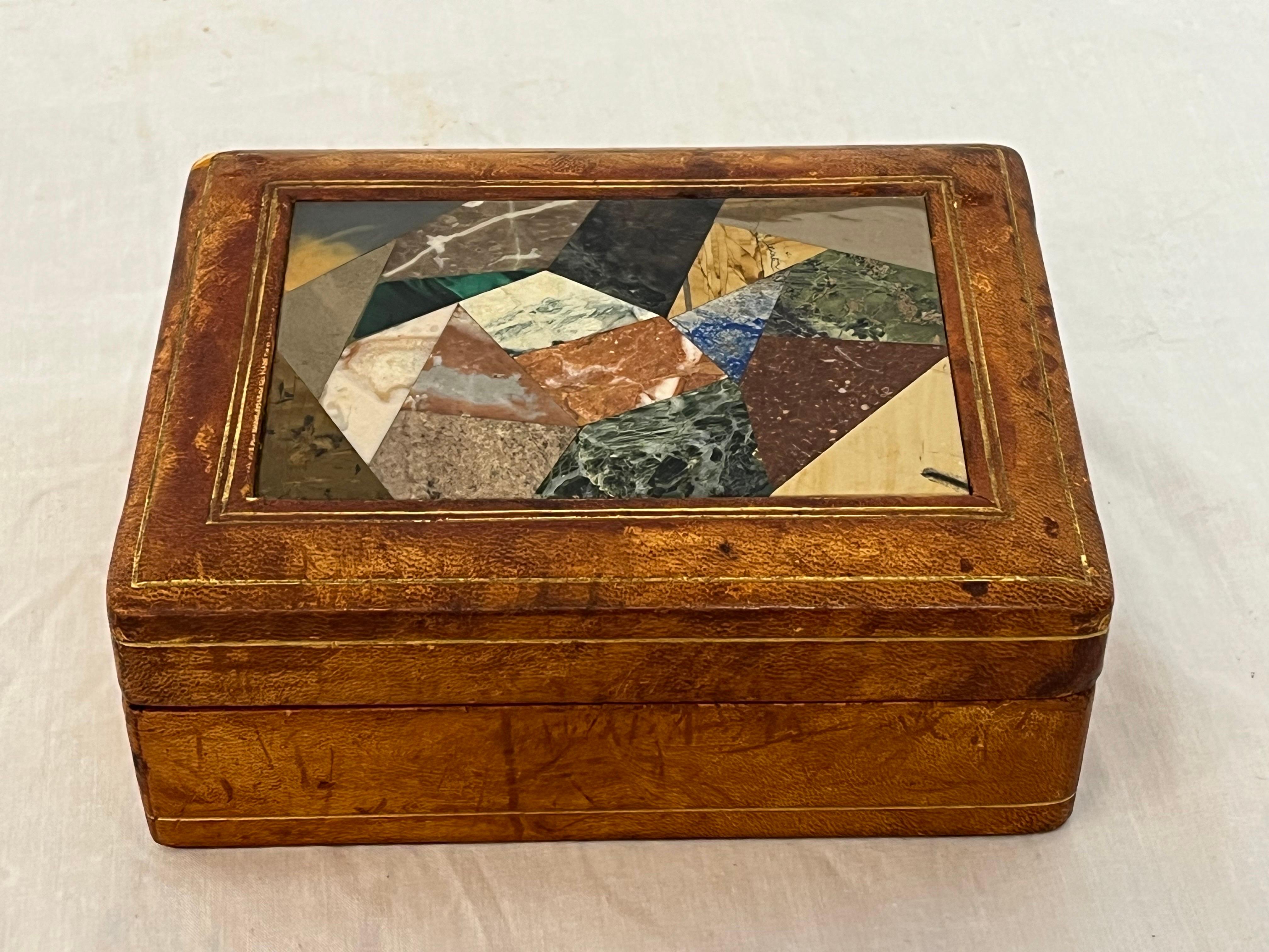A well loved Italian mid century pietra dura abstract inlaid leather and gilt clad card or stash box. The inlaid pietra dura abstract mosaic style top embodies that wonderful specimen marble feeling as well as the mid century vibe. The patina on the