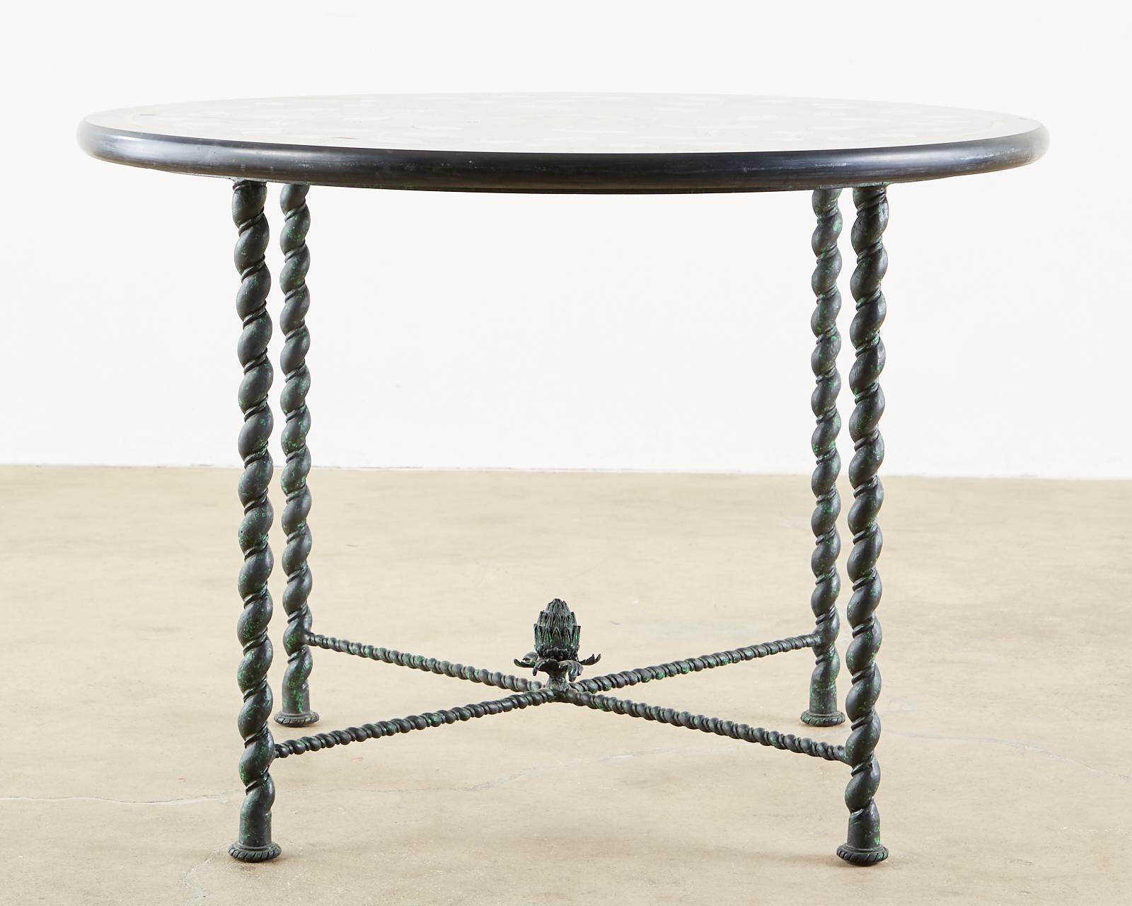 Stunning Italian centre or garden table featuring a pietra Dura marble, mosaic inlay top. The marble top is 1.5 inches thick decorated with colorful floral reserves over a dramatic black ground. The round marble top has a bull nose edge and is
