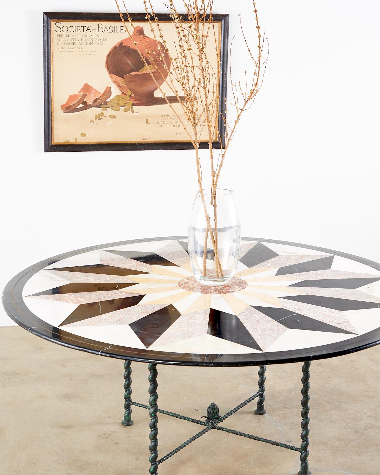 Exquisite Italian Pietra Dura garden table or dining table featuring a large round marble mosaic specimen top. The marble inlay is decorated with fascinating neoclassical style geometric designs. Supported by a bronze base having barley twist leg