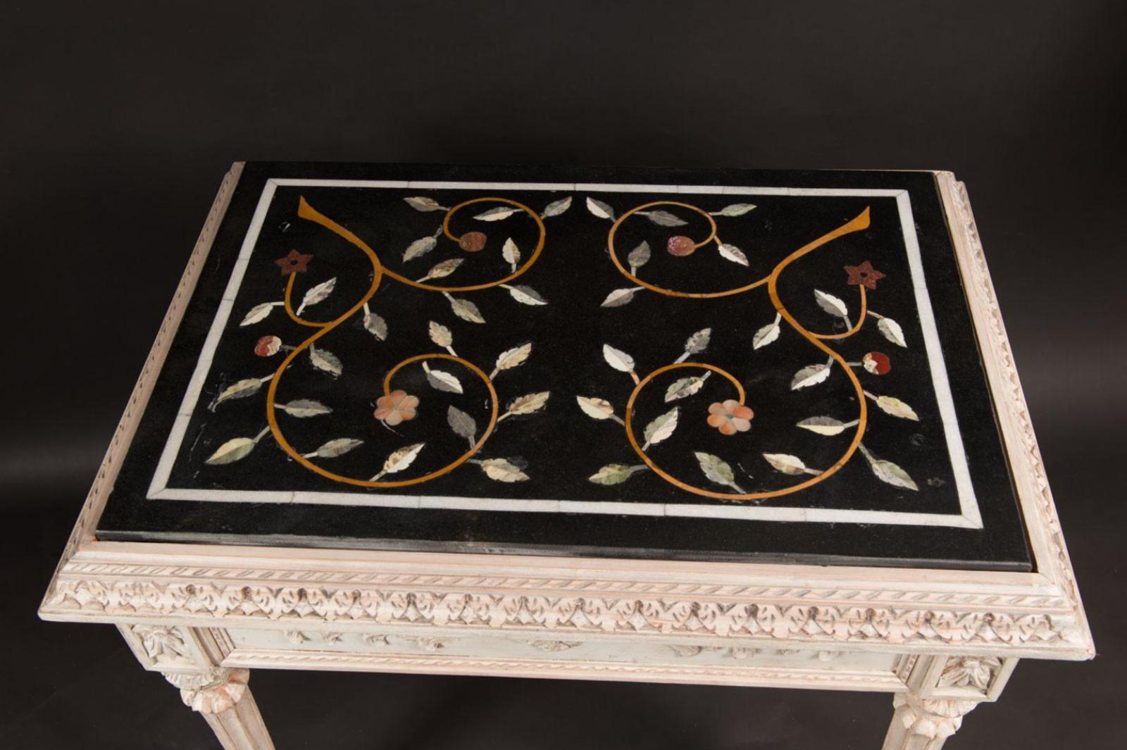 Italian pietra dura table 19th century

rectangular shape, with wooden caved based, four fluted and turned legs, classical frieze and stepped border, white painted, 
Italy
19th century, the pietra dura marble top with multi coloured stones, with