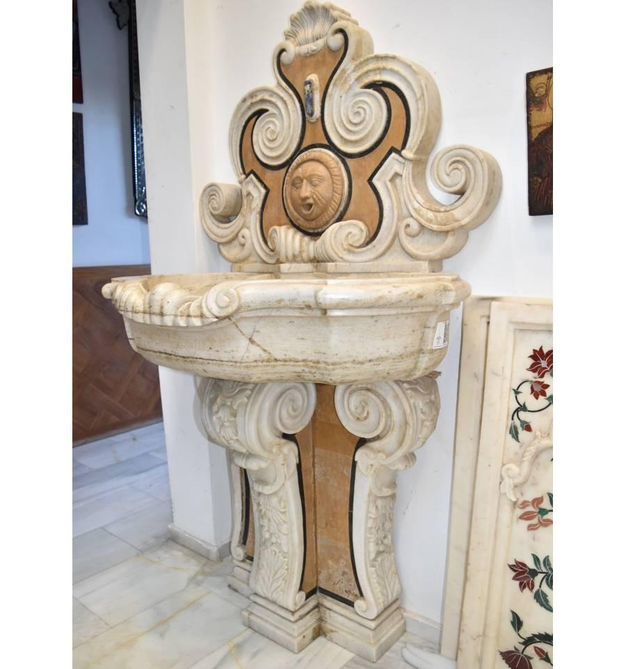 Aged marble fountain decorated in the Italian Pietre Dure mosaic inlay technique, with Renaissance style shell and floral motifs.