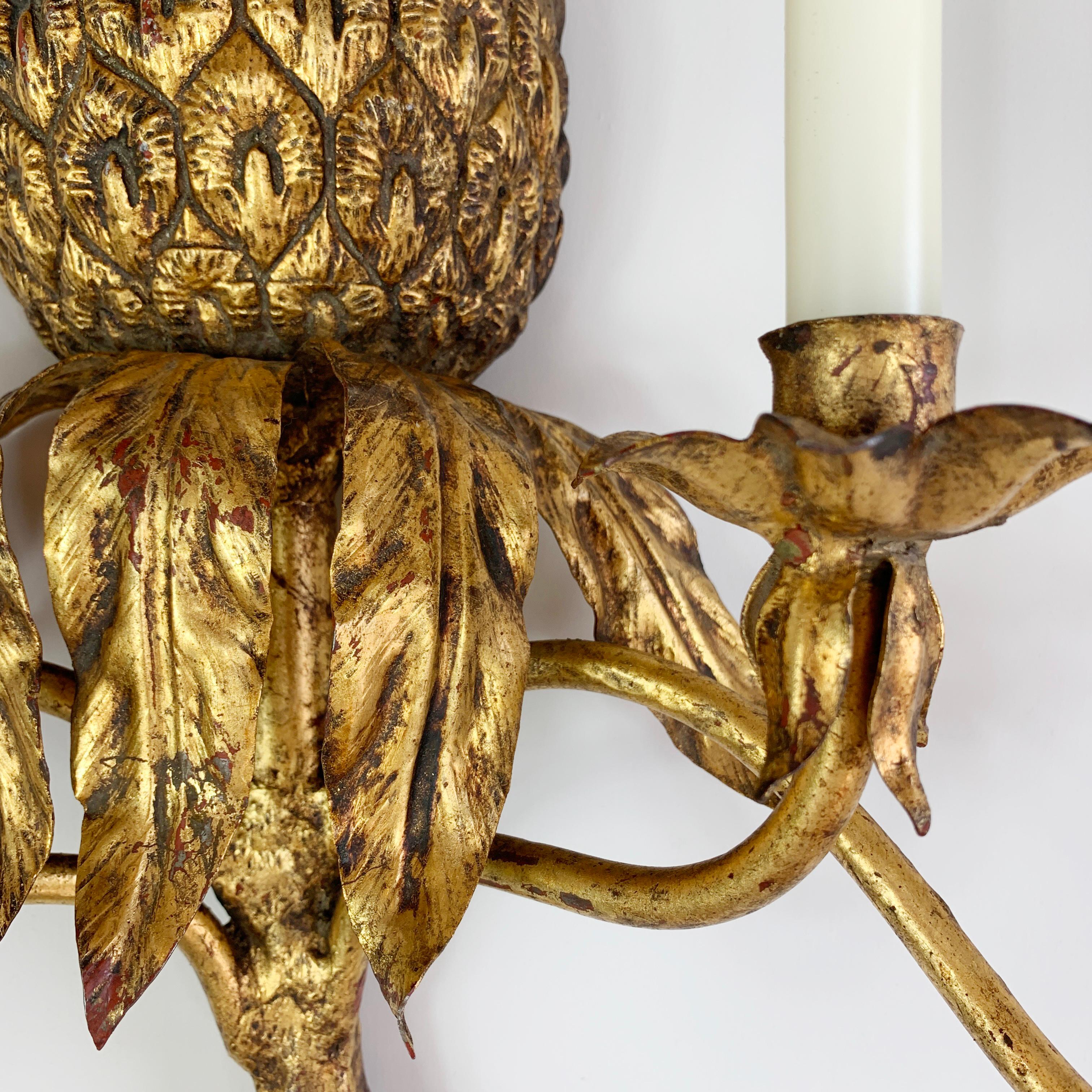 A beautiful Italian candle wall sconce, dating to the 1950’s, made from wrought iron, it is fully gilt covered, and is formed as a half pineapple, with top and base frond detailing. This piece is of really good proportions, and the detailing to the