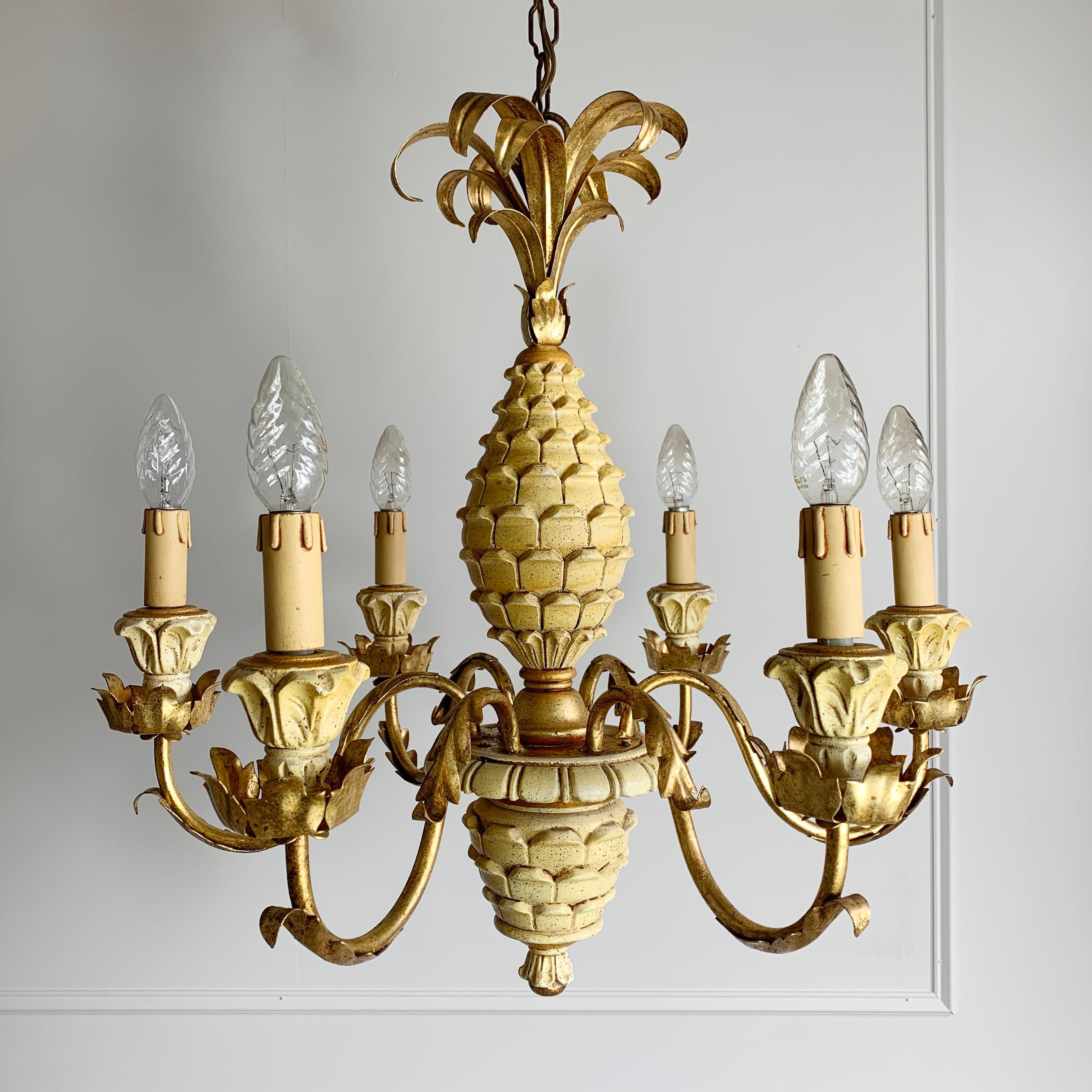 Beautiful carved pineapple chandelier with gilt acanthus leaf details and gilt fronds
Soft buttermilk tones with gilt
There are 6 arms each carrying a single lamp holder (e14)
The chain leads to the original git ceiling rose
Measures: 80cm total