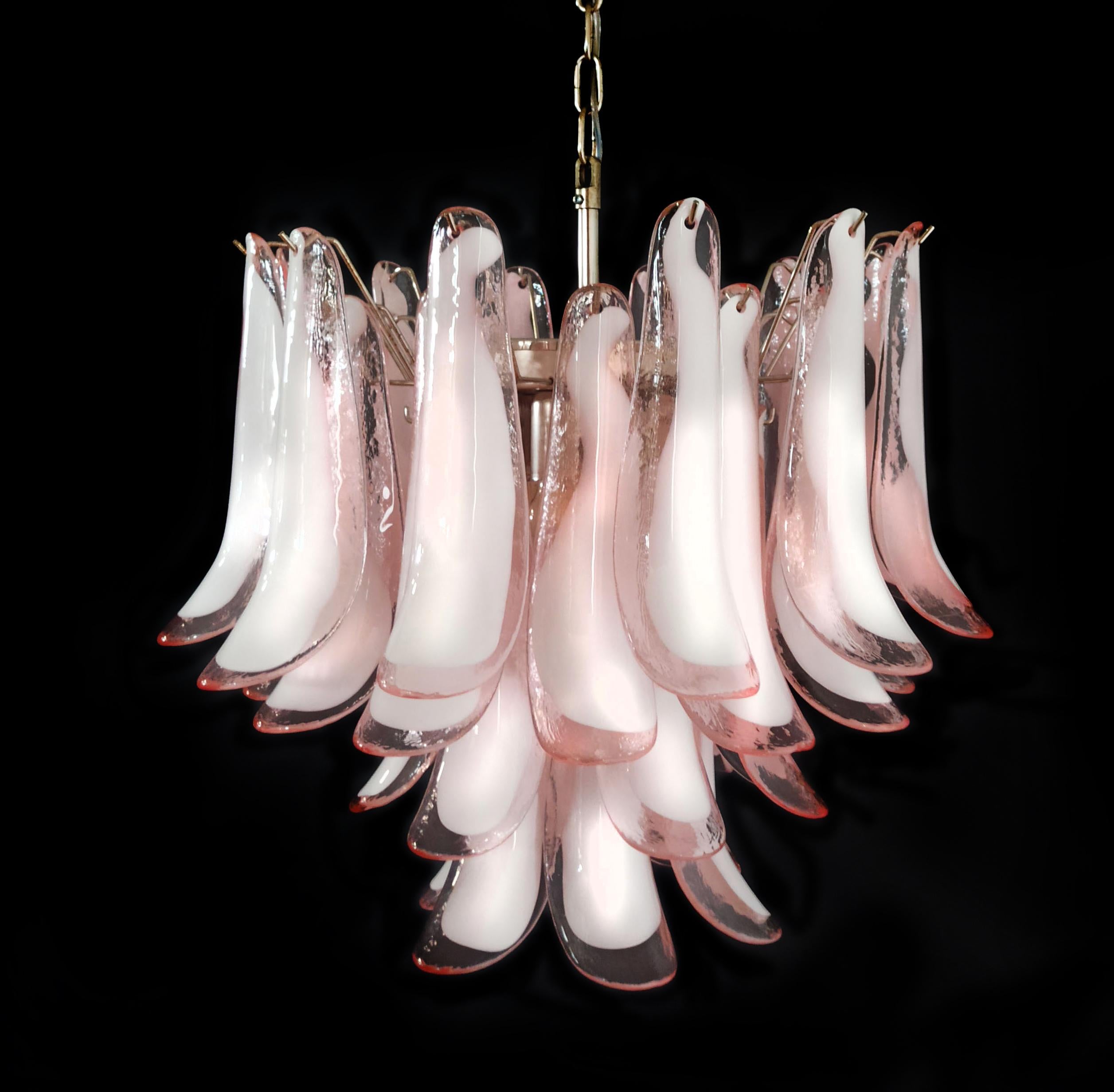 Fantastic chandelier with pink and white “lattimo” glasses, nickel-plated metal frame. It has 36 big monumental petals glass. The glasses are very high quality, the photos do not do the beauty, luster of these glasses.
Period:late XX