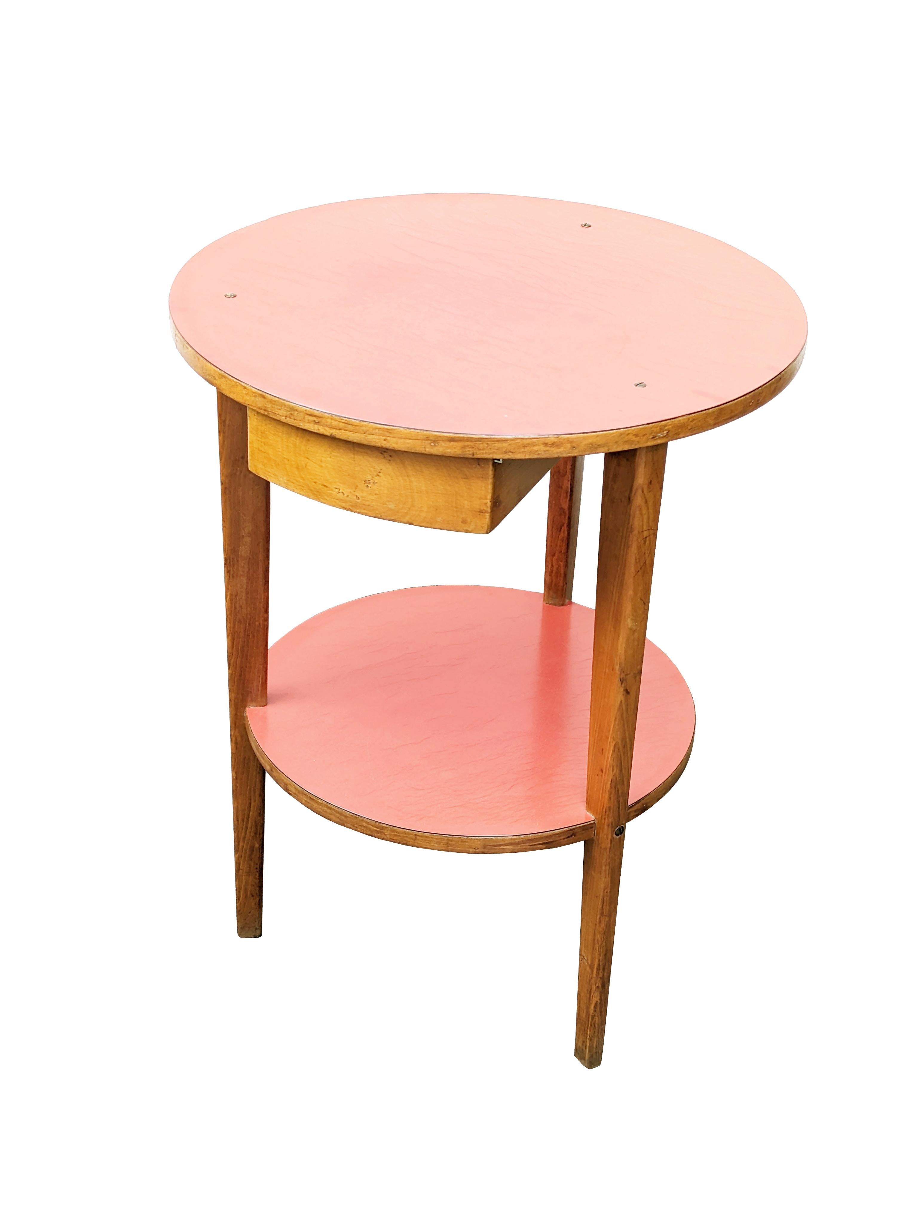 Side table or bedside table with drawer made of wood and 2 laminate top surfaces. It remains in good vintage condition: visible defects of the pink/red plastic laminate (see detailed pictures).
