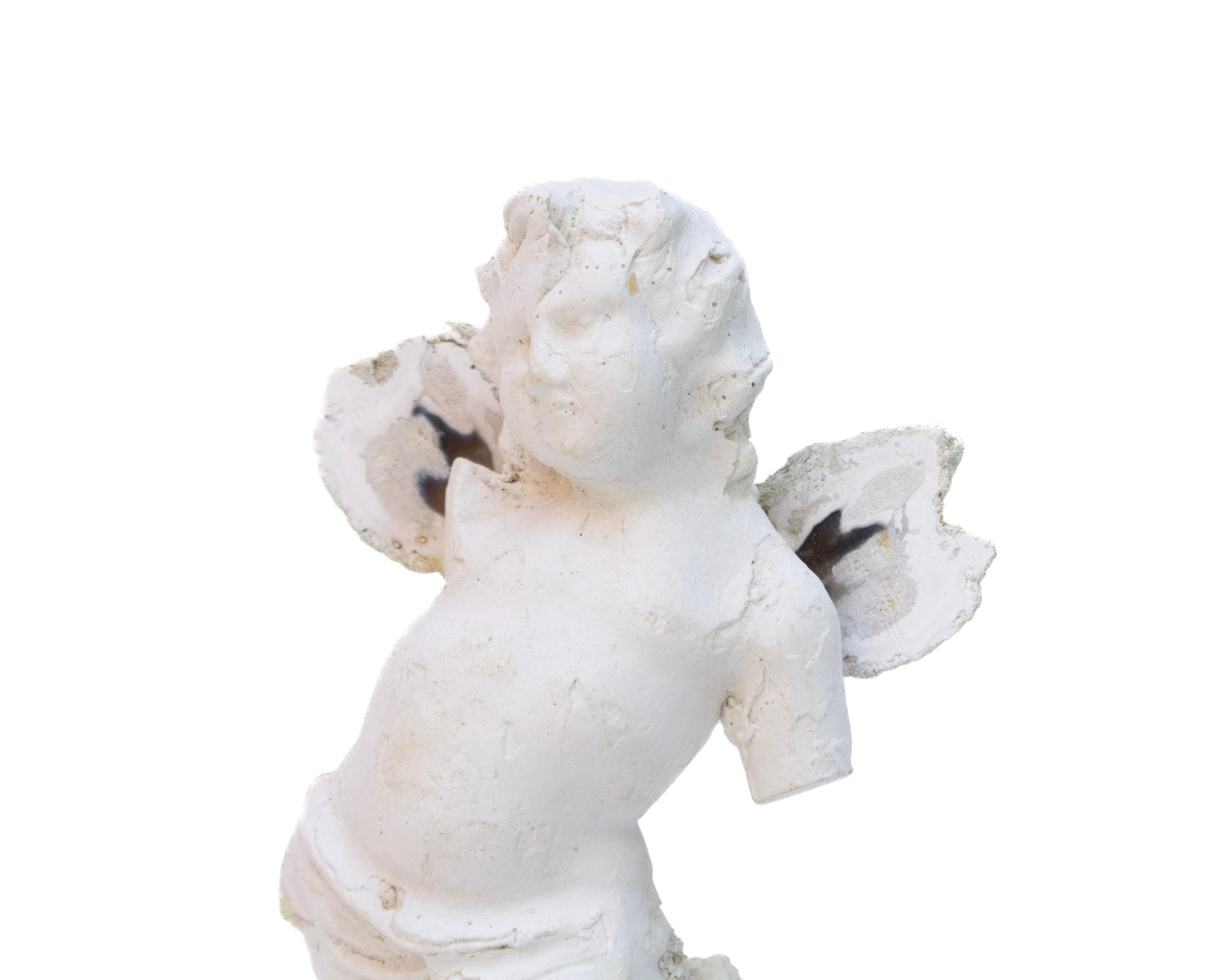Italian plaster cherub with coordinating polished agate coral wings on fossil agate coral.

Fossil agate coral is Florida's state stone and is known for its unique formation that can take place over 20 million years. It's a natural gemstone that is