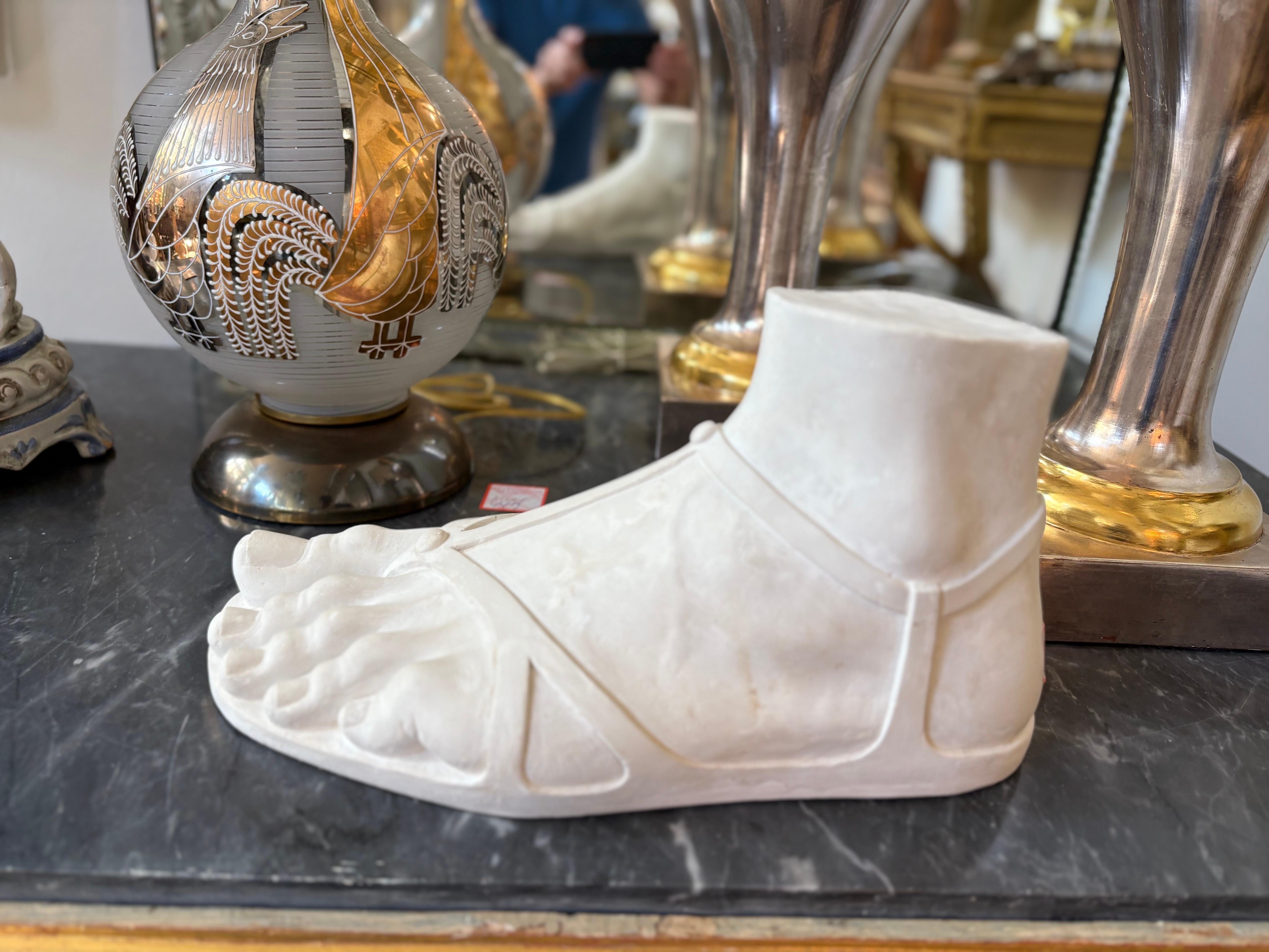 Italian Plaster Foot With Sandal.
Offered is a realistic Italian plaster foot with a sandal after the original classical Greek.
Our beautiful academic plaster foot sculpture would look excellent in a Contemporary, Mid Century, Hollywood Regency,