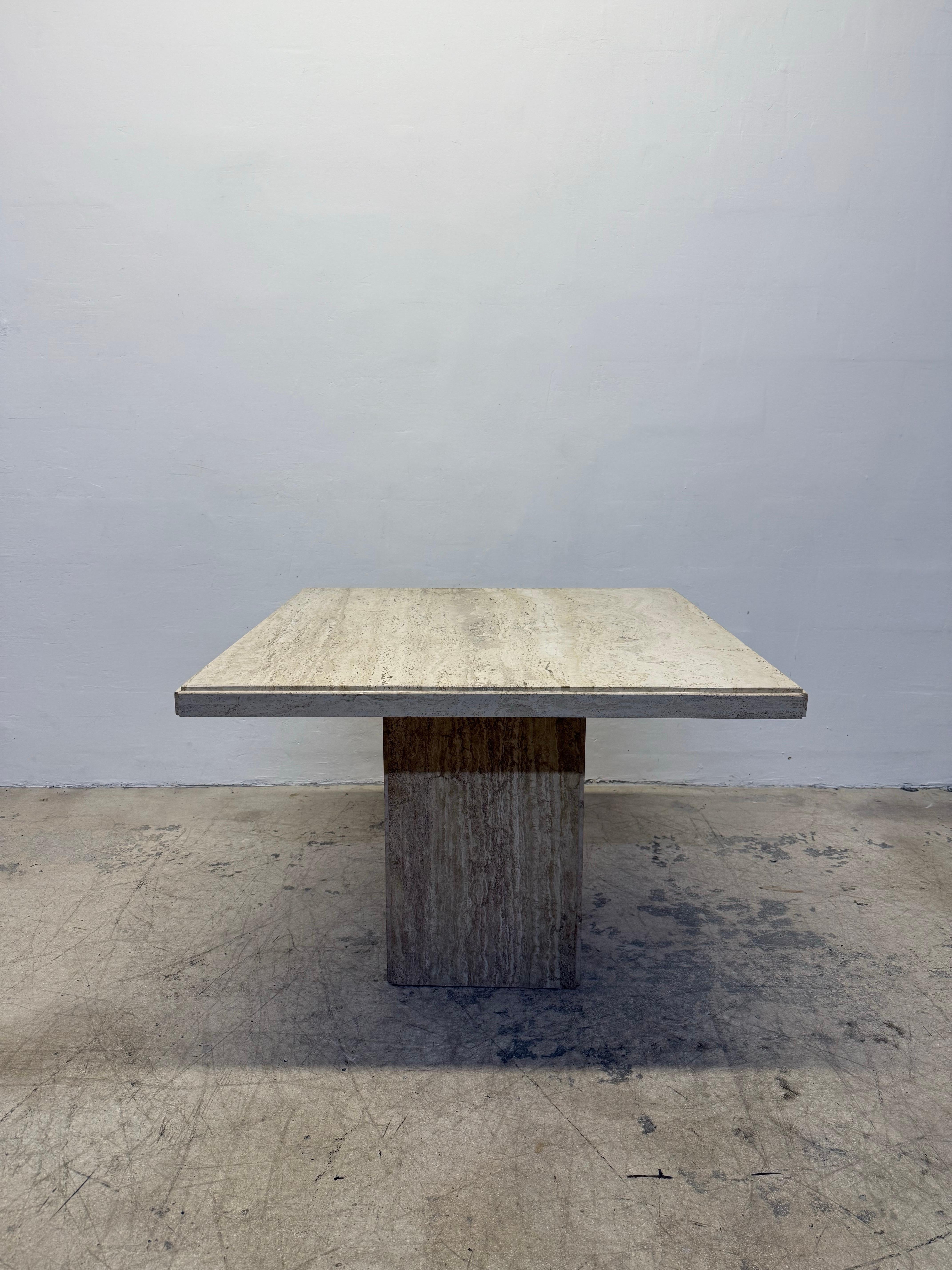 Mid-Century Italian travertine dining or center table from the 1970s.  Top has a satin finish with minimal sheen.