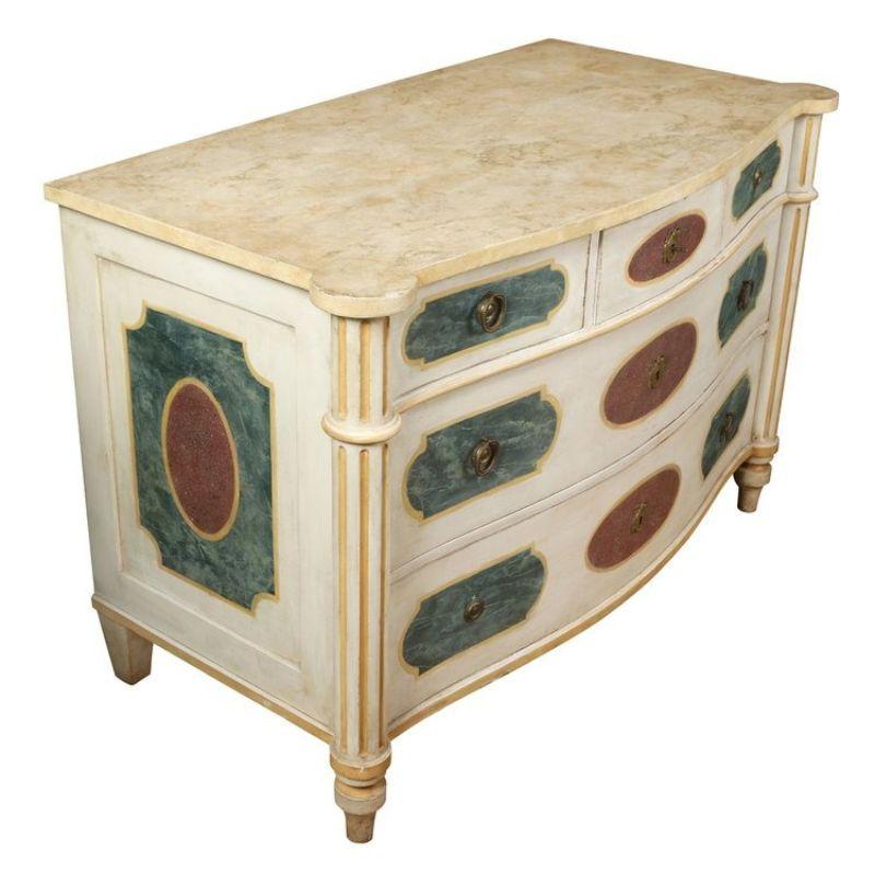 Italian polychrome three drawer ivory commode with coral and jade painted detail and faux marble top. Shaped front and reeded tapered legs.