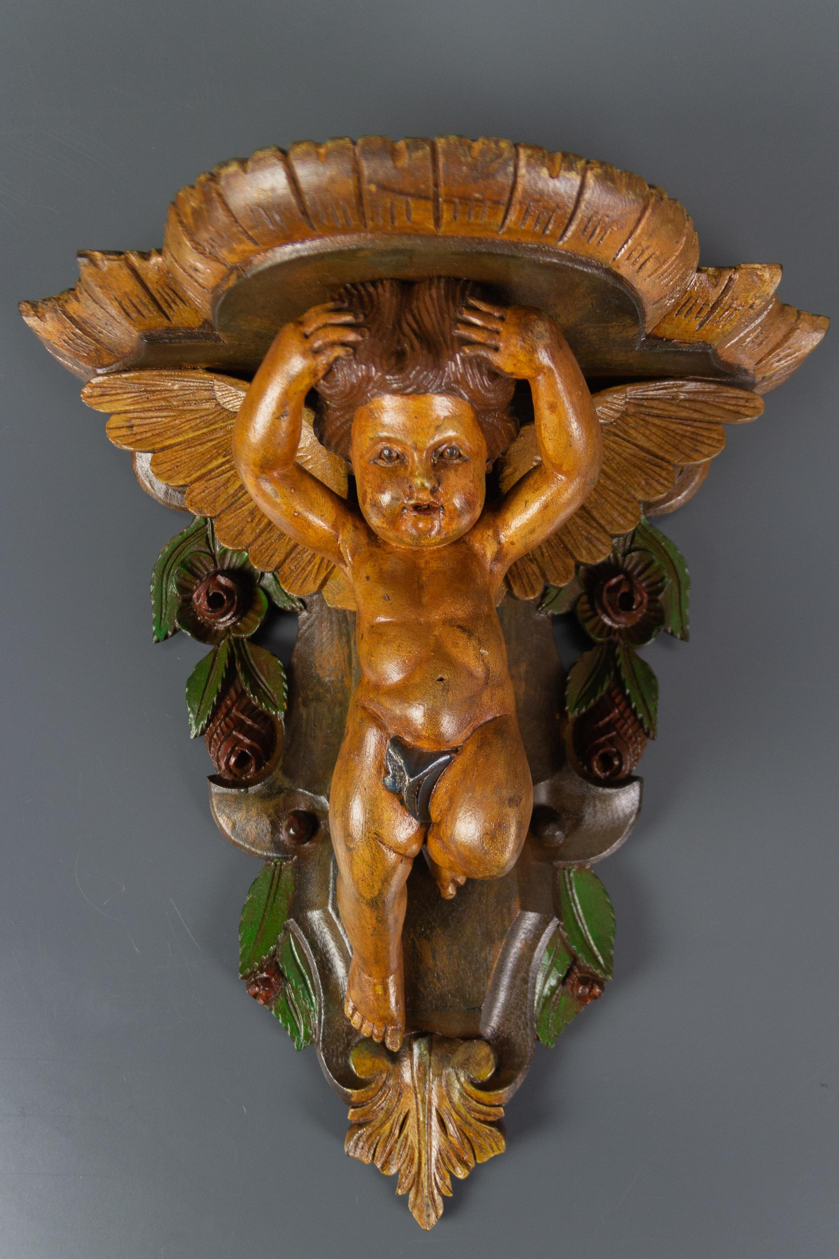 An adorable and colorful wooden wall bracket or shelf with an angel figure. Beautifully decorated with flowers and leaves. Italy, the 1950s.
Dimensions: height 40 cm / 15.74 in; width 37 cm / 14.56 in; depth 18 cm / 7.08 in.