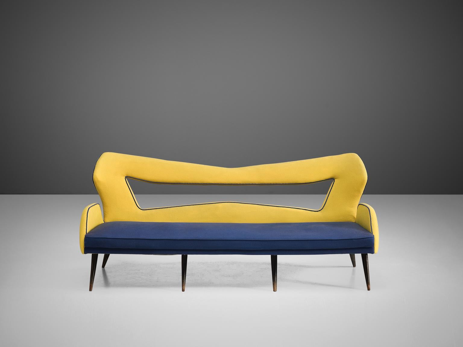 Sofa, blue and yellow upholstery, wooden legs, Italy, 1970s.

This settee is extraordinary in its playfulness and color scheme. The sofa features four wooden tapered, diagonal legs. The seat, upholstered in marine blue upholstery, is thick and