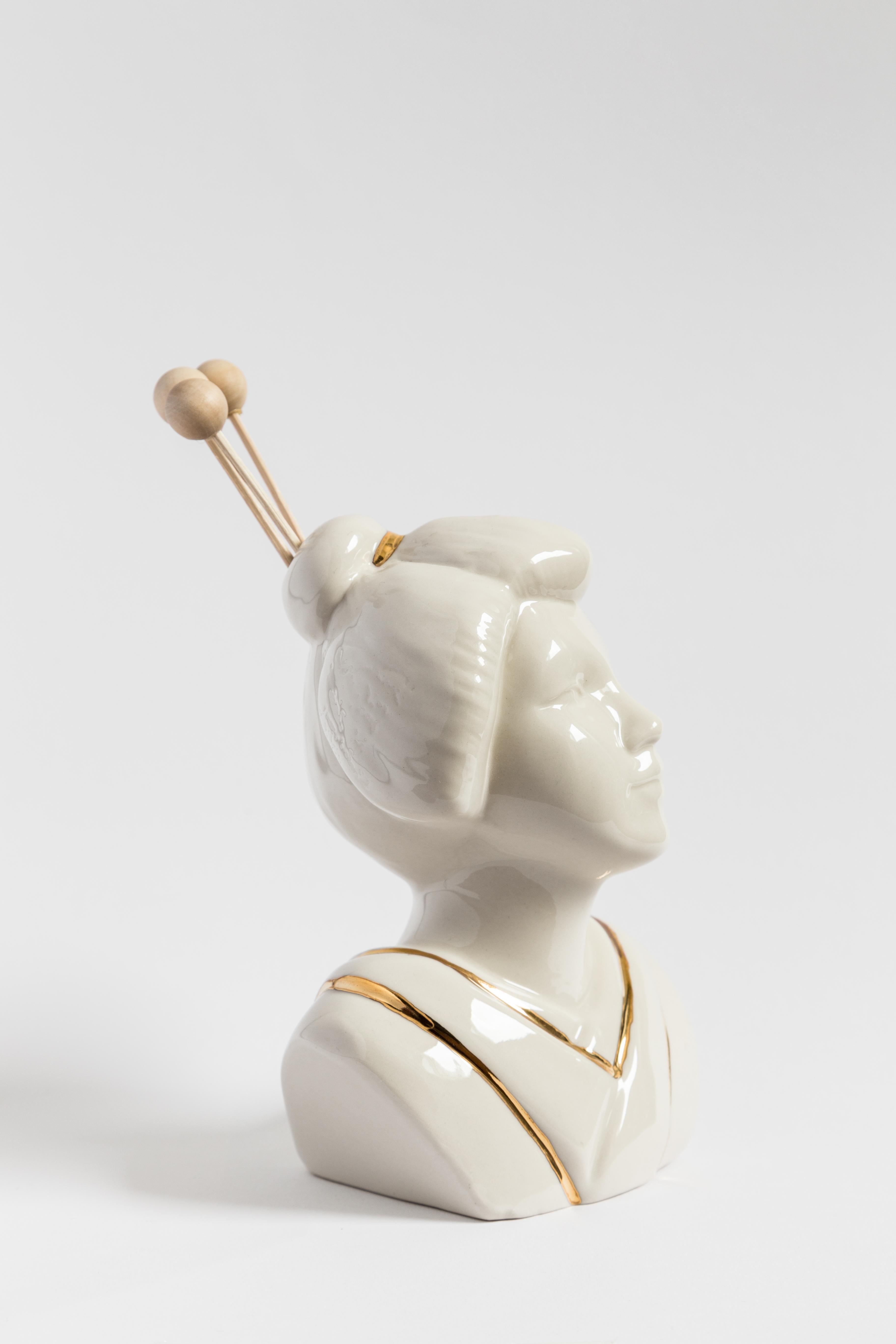This Italian porcelain sculpture is part of Grand Tour by Vito Nesta. Made in Capodimonte porcelain with a glossy finish and gold detail, this sculpture is an essential oil diffuser and is shaped like a Japanese woman.