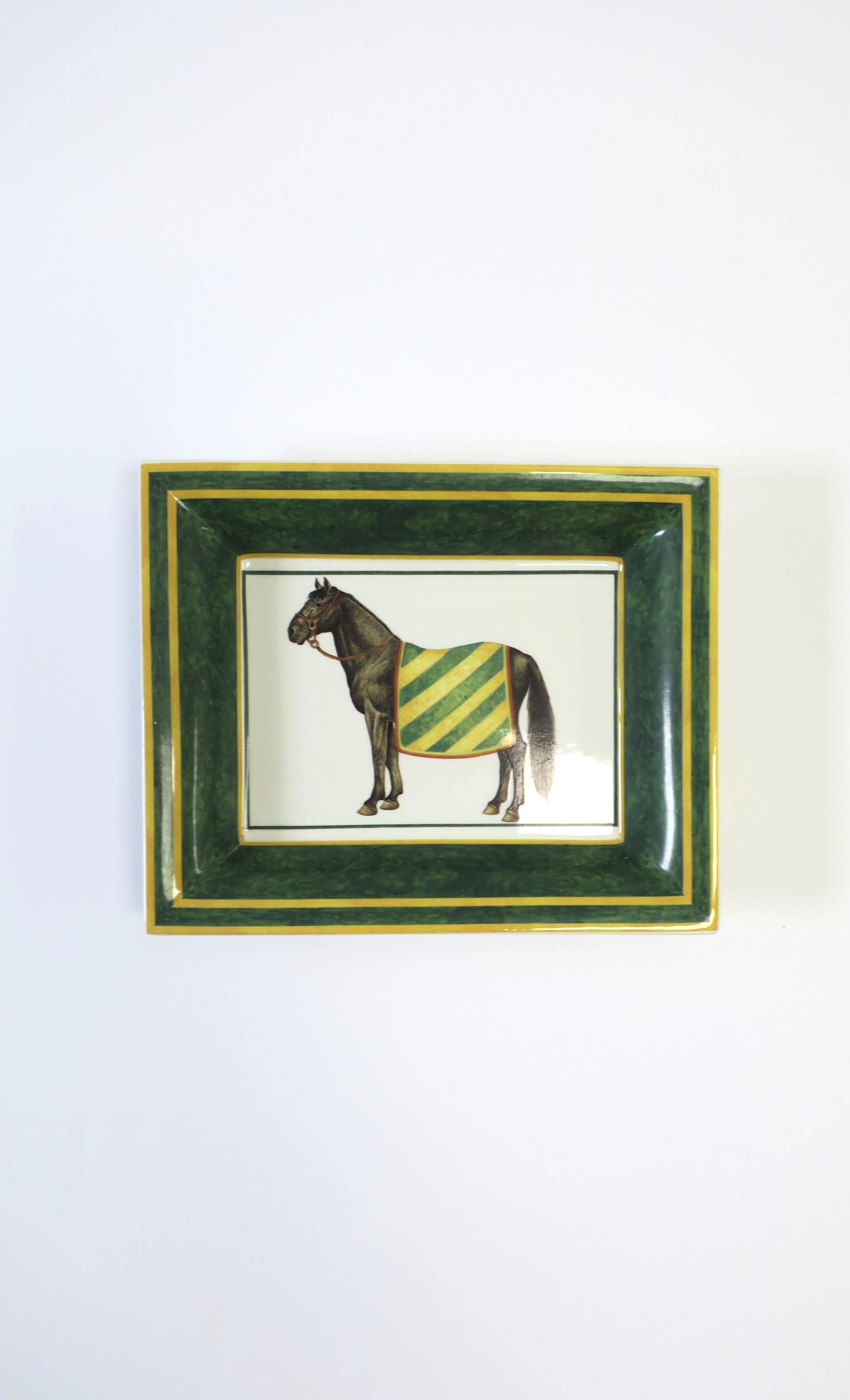An Italian porcelain jewelry tray catchall/vide-poche dish with center thoroughbred equestrian, circa mid to late-20th century, Italy. Piece has a beautiful portrait of a black horse with colorful blanket. Colors include white porcelain, brown,