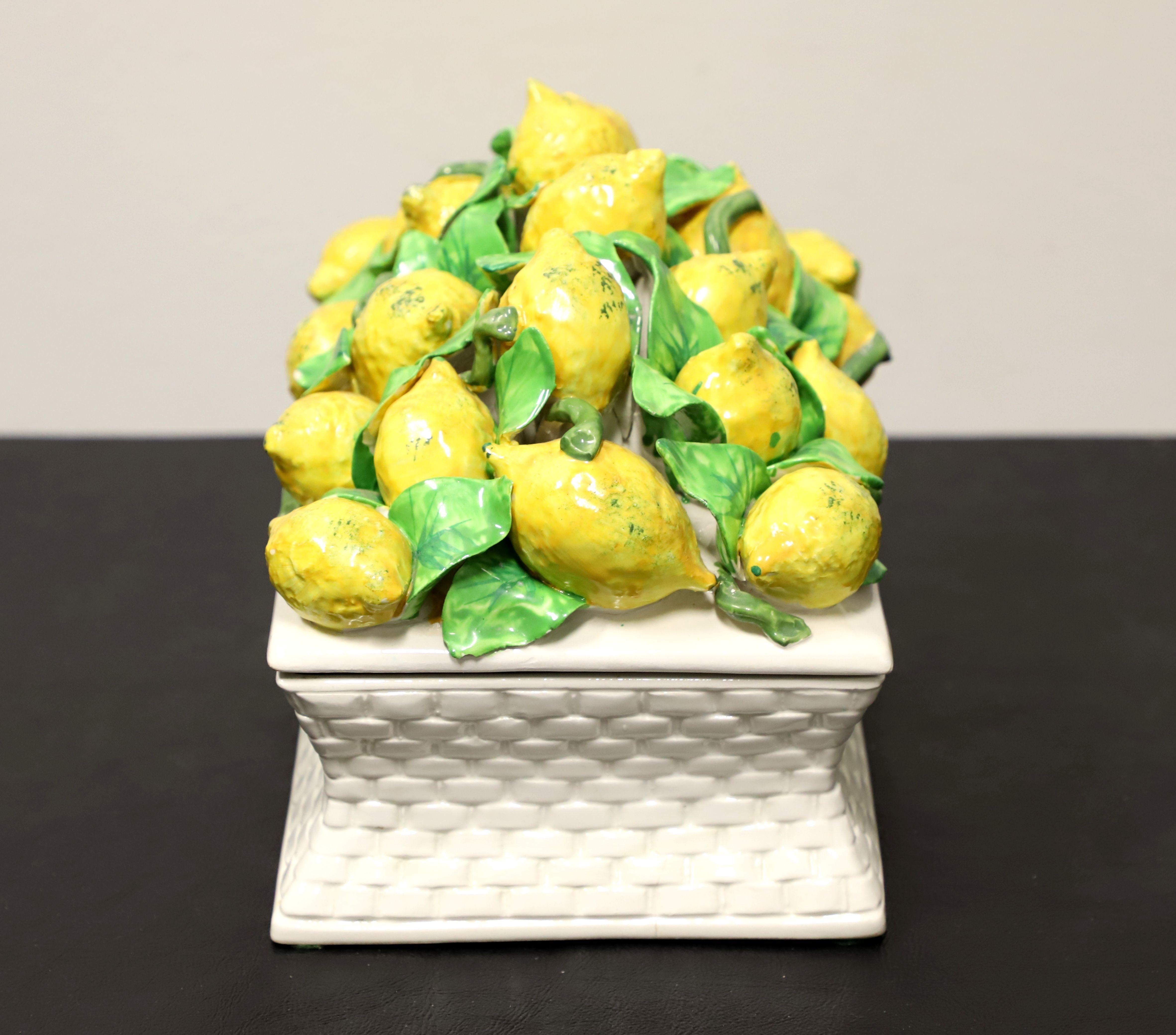 A Late 20th Century decorative porcelain centerpiece dish, unbranded. A basket weave design to lower porcelain dish and a collection of porcelain lemons and leaves to the lid. Rectangular in shape with a smooth interior for foods or trinkets. Made
