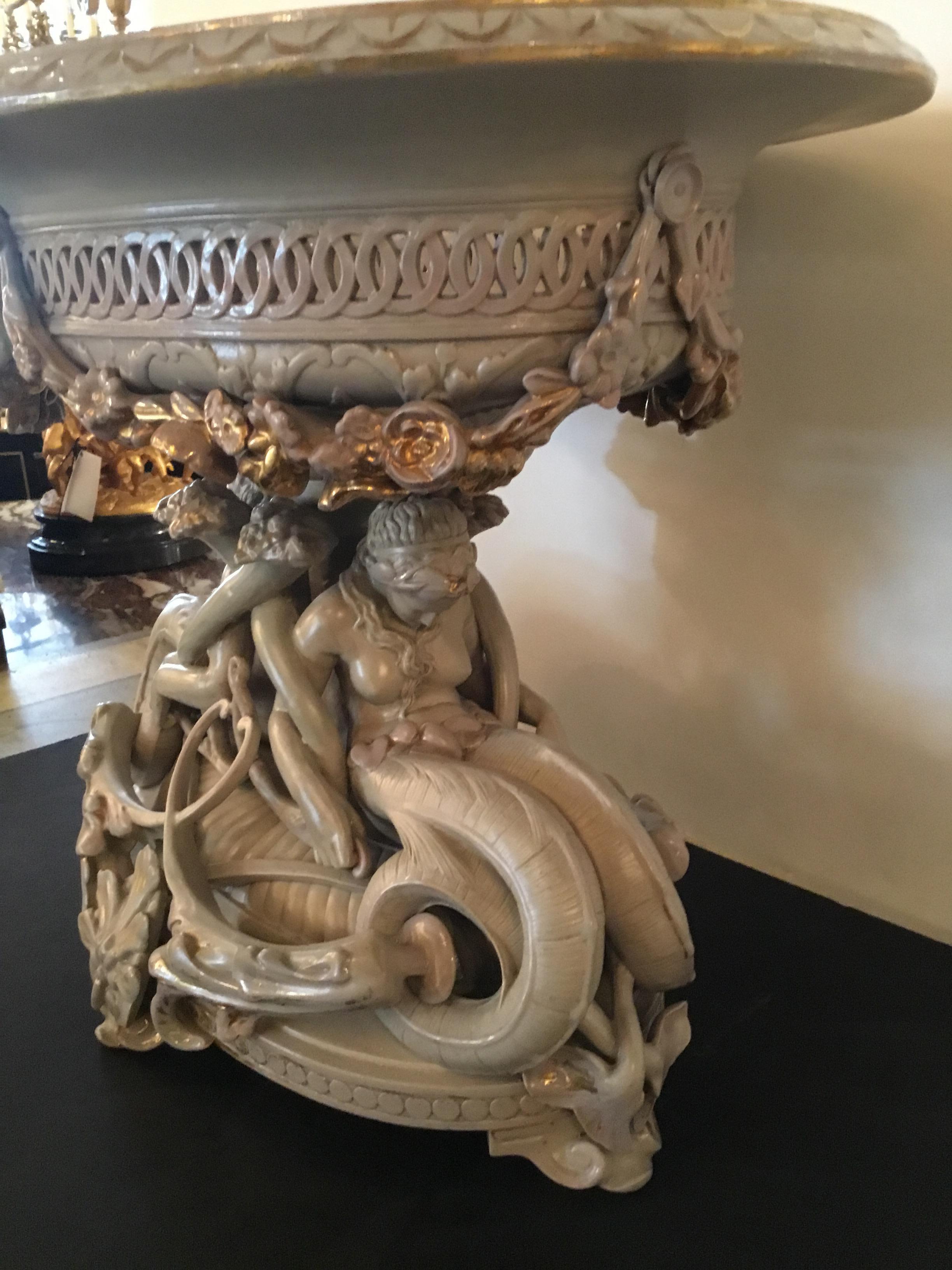 Large and impressive parcel gilt compote having a draped rim
And pierced border decorated with rose garland swags.
The base uniquely styled with serpent maidens, cornucopia,
And stylized leaf sprays.
