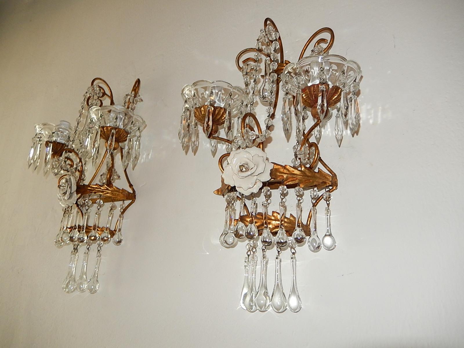 Will be rewired with certified US UL sockets for the USA and appropriate sockets for all other countries and ready to hang!  Housing 2-light each, sitting in crystal bobeches dripping with crystal prisms on top of giltwood posts. Gold tole with