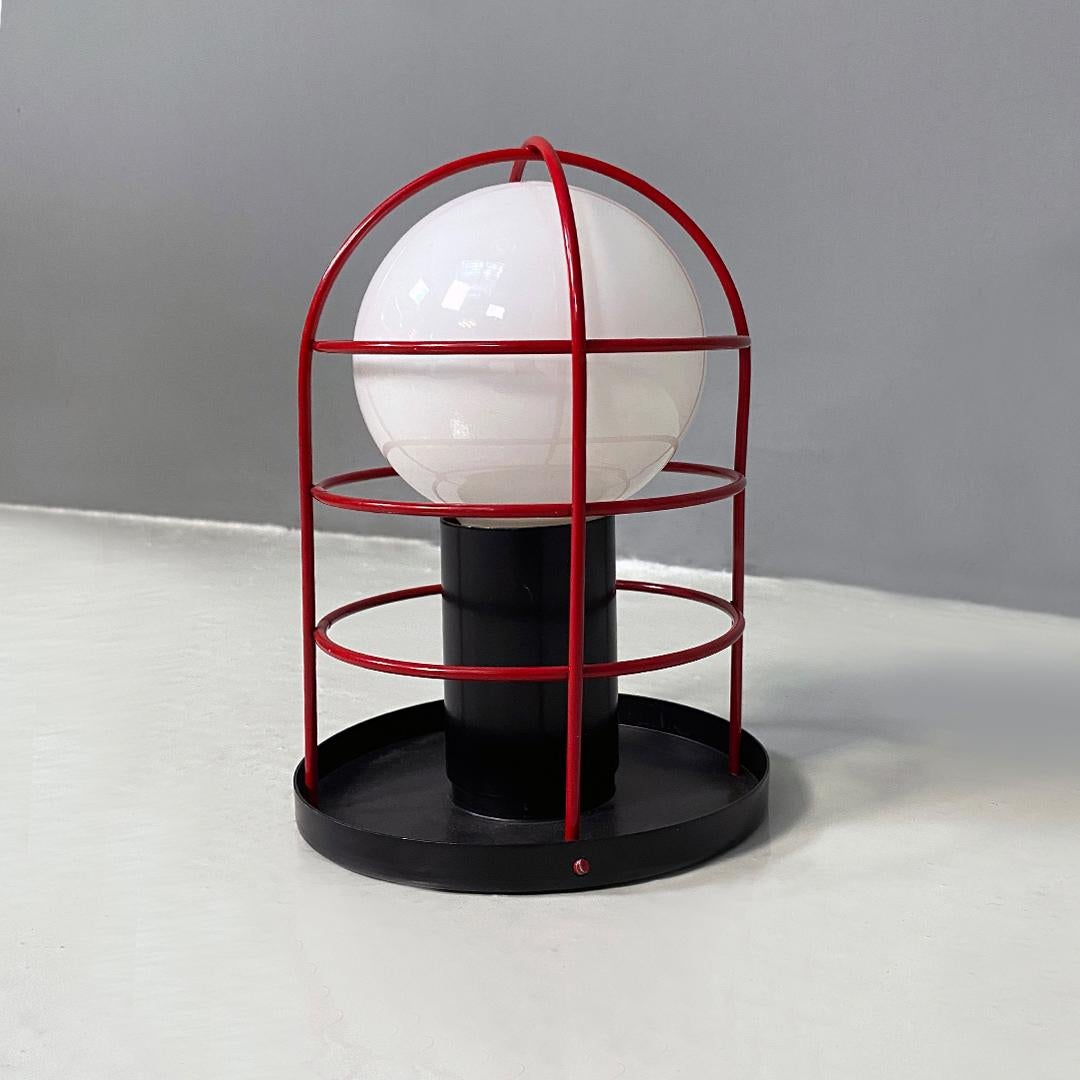 Beautiful Italian post modern black and red metal wall, table or ceiling lamp by Targetti, 1980s.
Fantastic and very pop style wall or ceiling lamp with round black metal wall attachment and external decorative grid that is reflected when the light