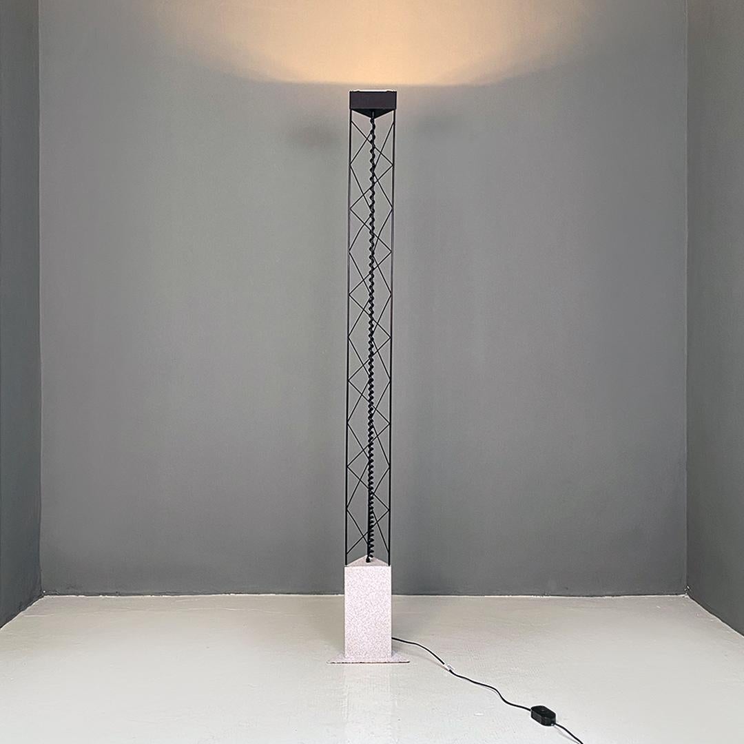Italian post modern black metal and sheet metal stone effect painted, triangular base floor lamp, 1980s.
Floor lamp with triangular section base in sheet metal, stone effect painted, upper part in black metal rod and electrical system cable with