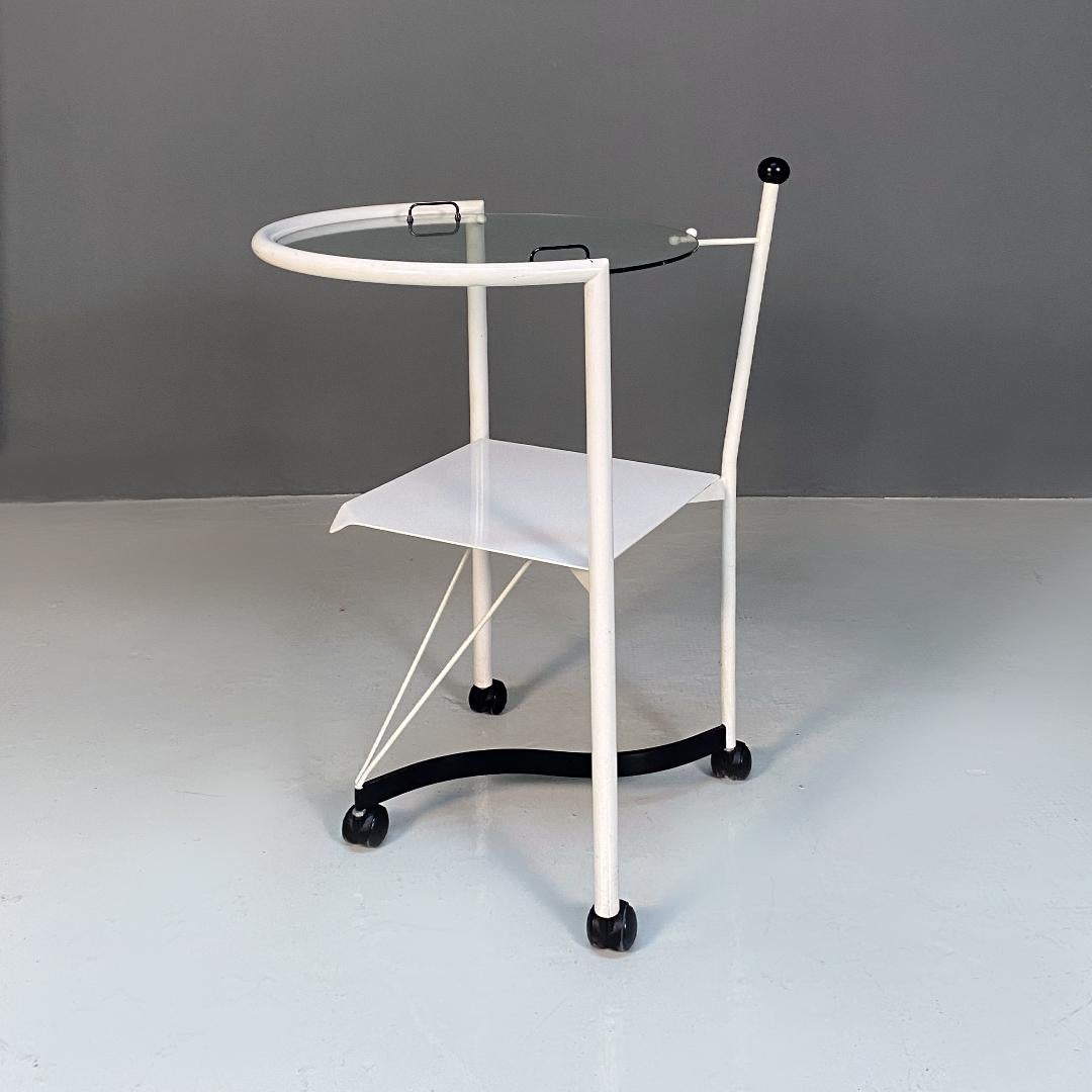 Italian post modern black and white metal and glass food trolley or coffee table, 1980s
Food trolley or tall coffee table on wheels with white metal structure with double shelf, of which the upper top is round in tempered glass and the lower one in