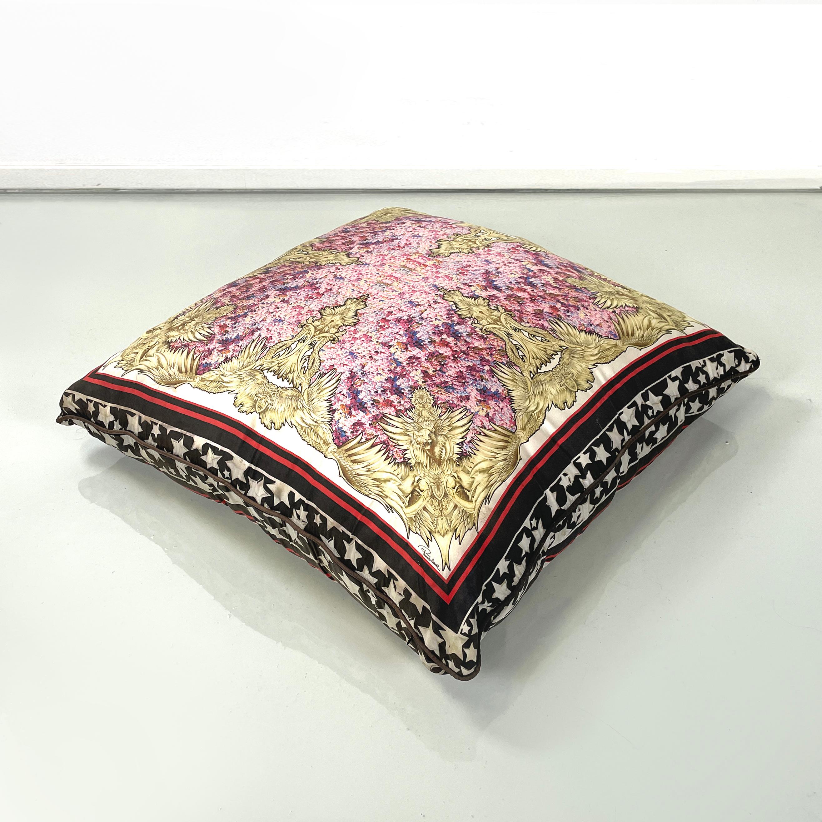 Italian post modern Fabric cushion with colored pattern by Roberto Cavalli, 2000s
Large square cushion in patterned fabric. In the center there is a floral decoration in pink-violet, framed by motifs of feathered wings and feline figures, in yellow.