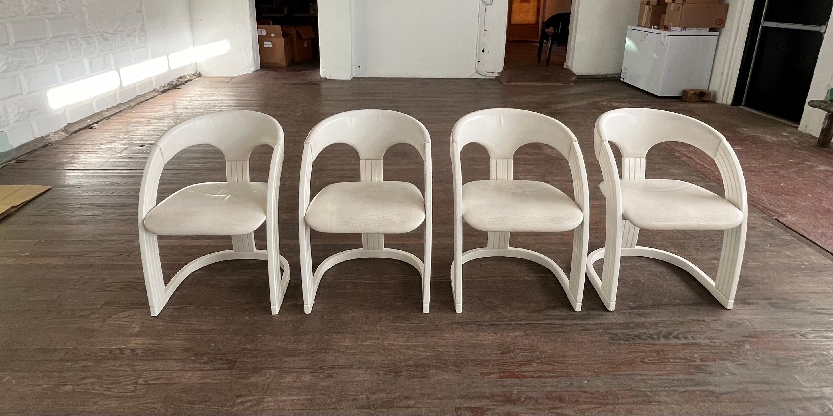 Set of 4 Italian Lacquer dining chairs with leather upholstery. Gentle curved design with channel grooves on sides. Labeled made in Italy. Leather shows wear. 
Curbside to NYC/Philly $300