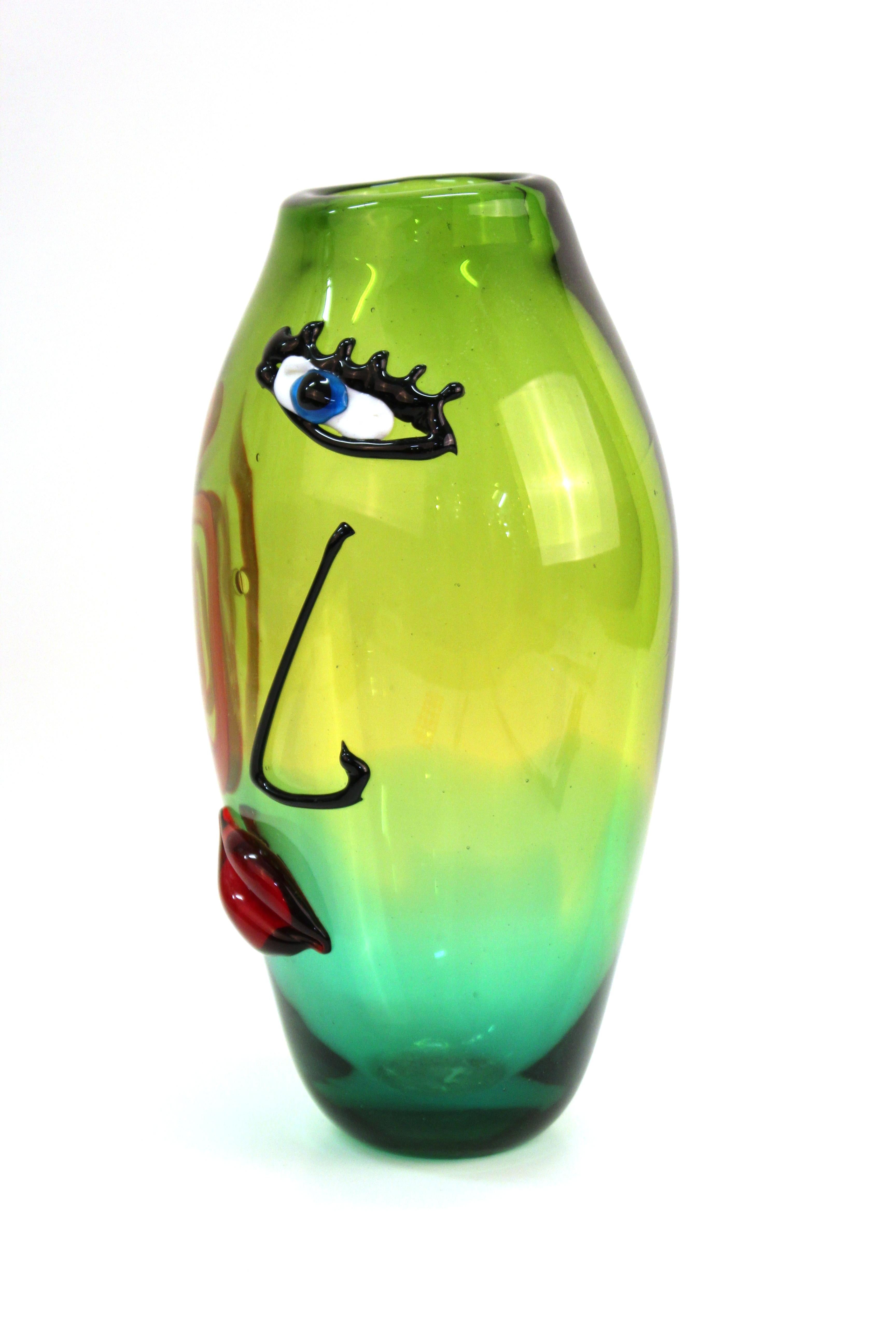 Italian Postmodern art glass vase attributed to Maestro Giuliano Tosi. The piece was made in Murano in the late 20th century and presents an abstract face with an eye on the front side. Murano glass label on the bottom. In great vintage condition