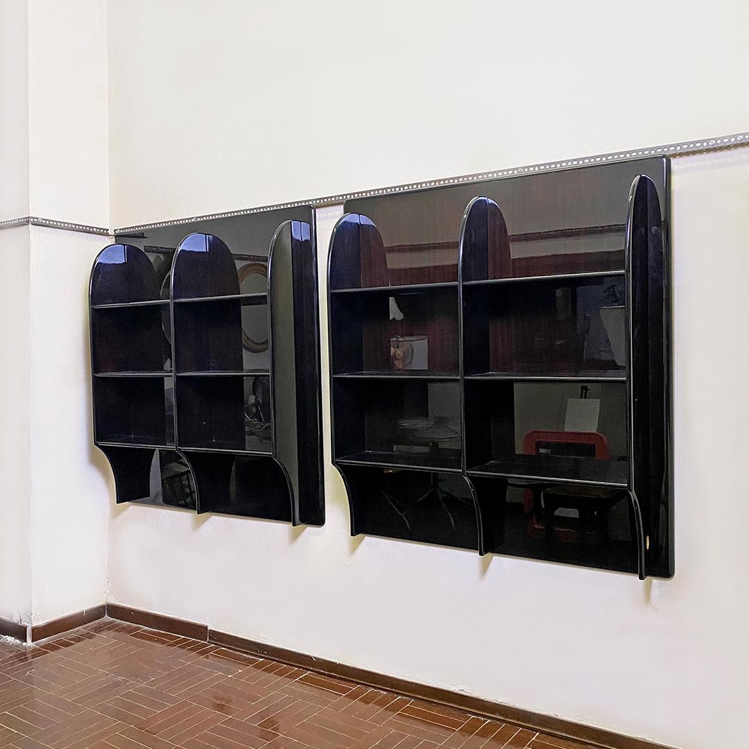 Italian post modern pair of black lacquared solid wood bookcases by Luigi Caccia Dominioni for Azucena, 1960s
Pair of wall bookcases, in black lacquered solid wood, with reddish reflections and with various shelves and rounded corners.
1960s
Good