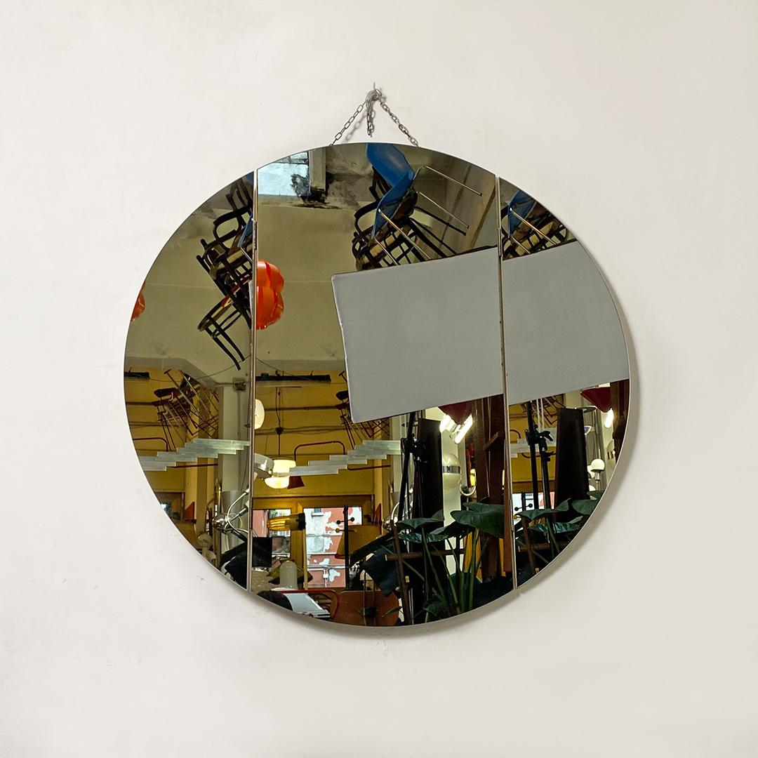 Italian post modern round wall mirror with hinged side doors, 1980s
Round wall mirror with fixed central part and hinged side doors, fixed to the first with metal hinges, to complete the round shape of the mirror.
1980s
Good general conditions,