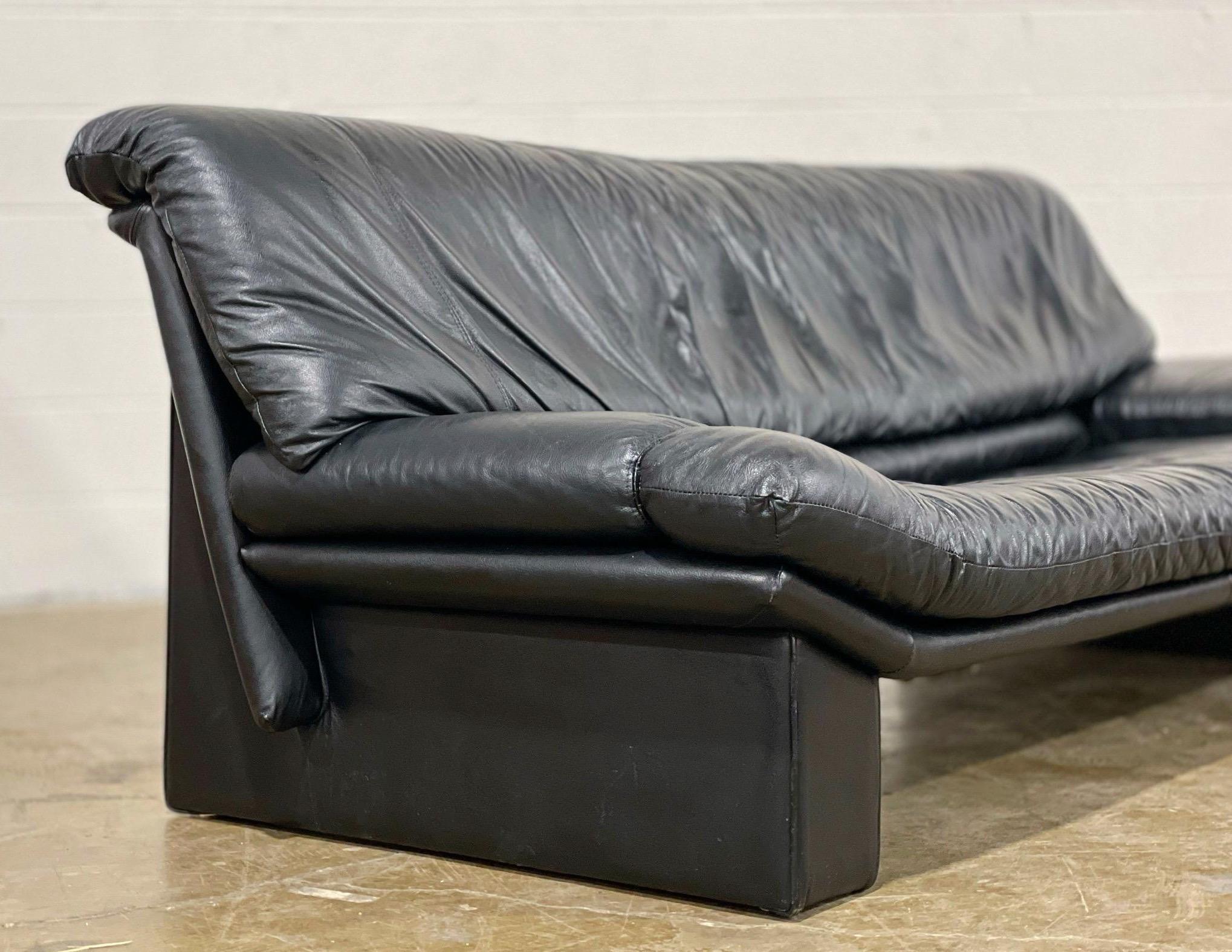 Stellar post modern sofa by Nicoletti Salotti, Italy circa 1980s. Finely appointed and fully dressed in high grade top grain black Italian leather. Striking and stark angular lines for a stunning silhouette. Attended to by our team of in house