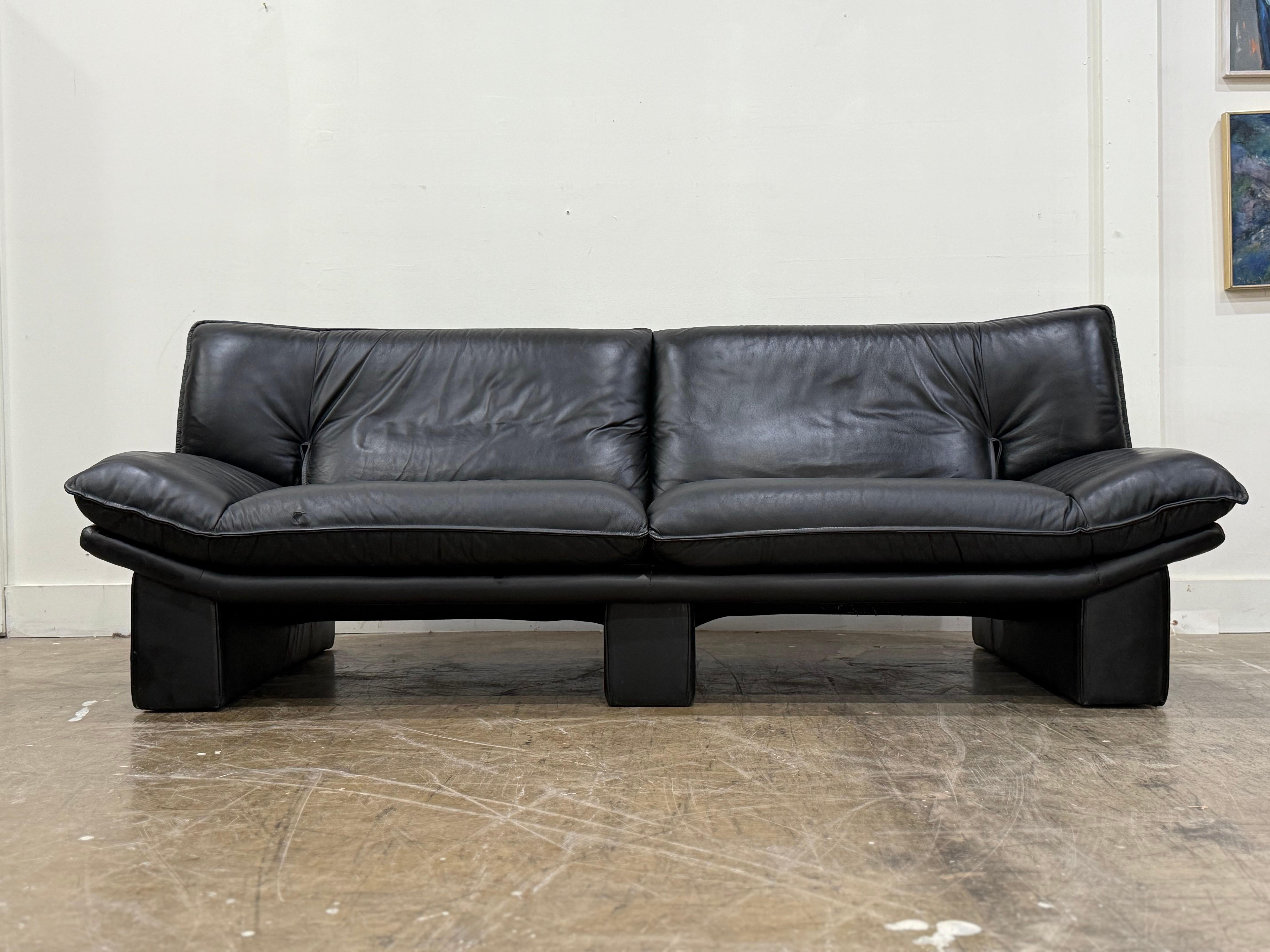 Stellar post modern sofa by Nicoletti Salotti, Italy circa 1980s. Finely appointed and fully dressed in high grade top grain black Italian leather. Striking and stark angular lines for a stunning silhouette. Attended to by our team of in house