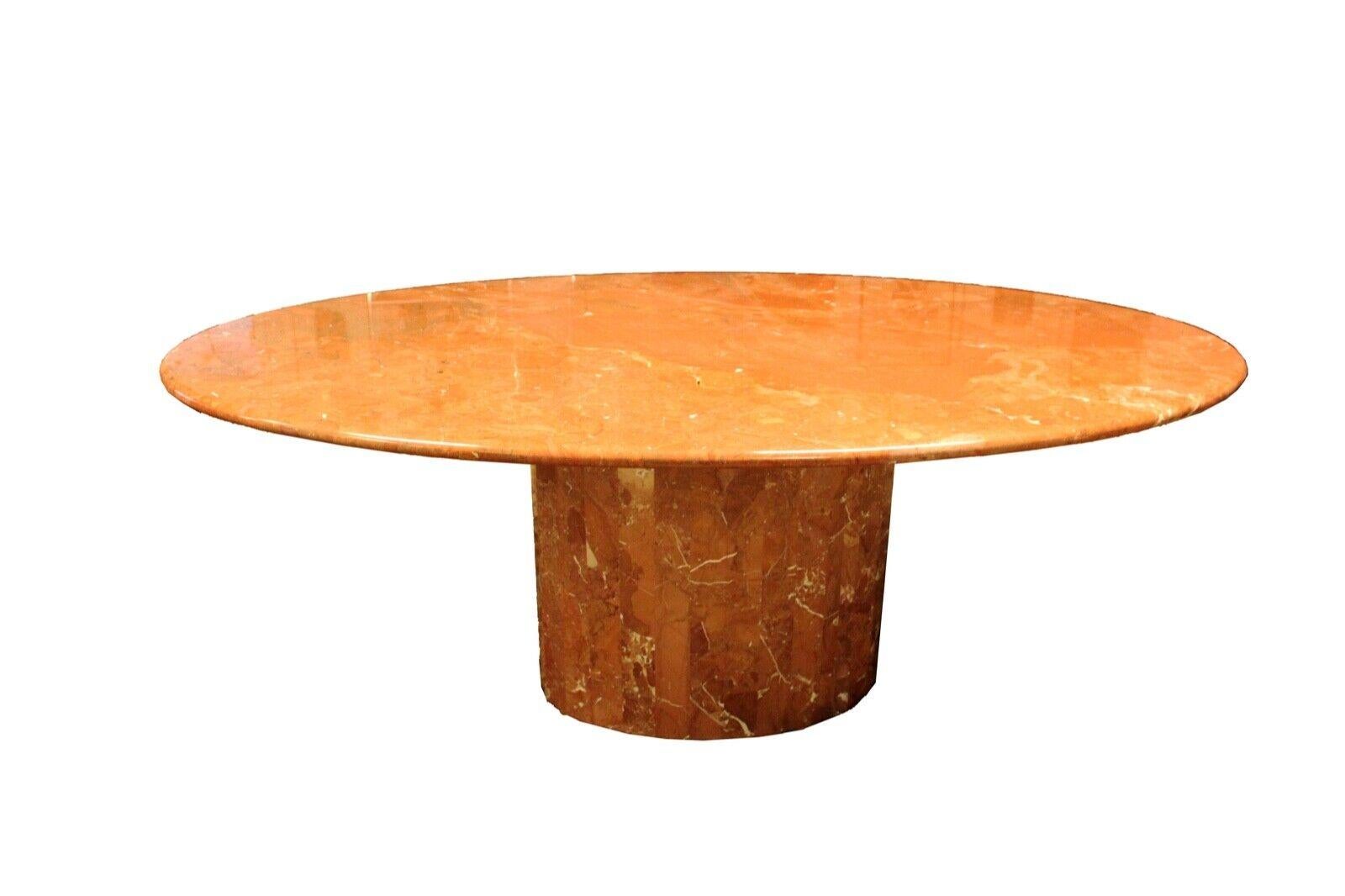 Italian Post Modern faceted base dining table. This captivating rust colored gorgeous marbled dining room table. In very good condition. Dimensions: 78.5