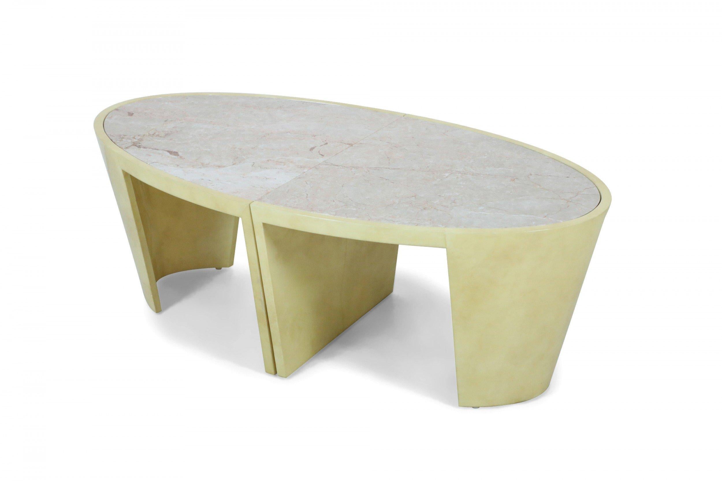 Italian Post-Modern oval coffee table in two sections with parchment veneer bases supporting beige Breccia Onitiata marble tops.