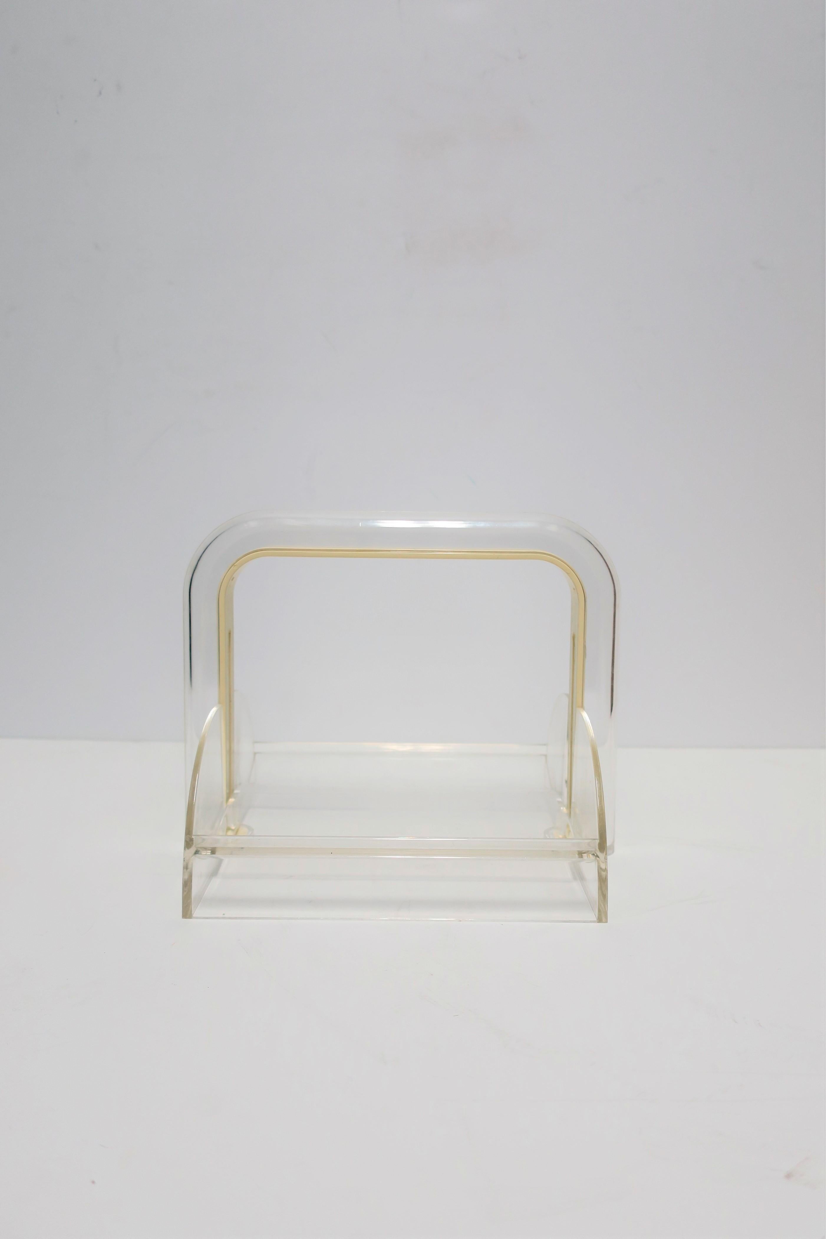 An Italian Postmodern clear acrylic napkin holder by designer Rede Guzzini, Italy 1980s - 1990s. With maker's mark in two places, on top and on bottom, 'Guzzini' 'Made in Italy', Shown in closeup image, image #11. Holds a 'standard' napkin size: 6