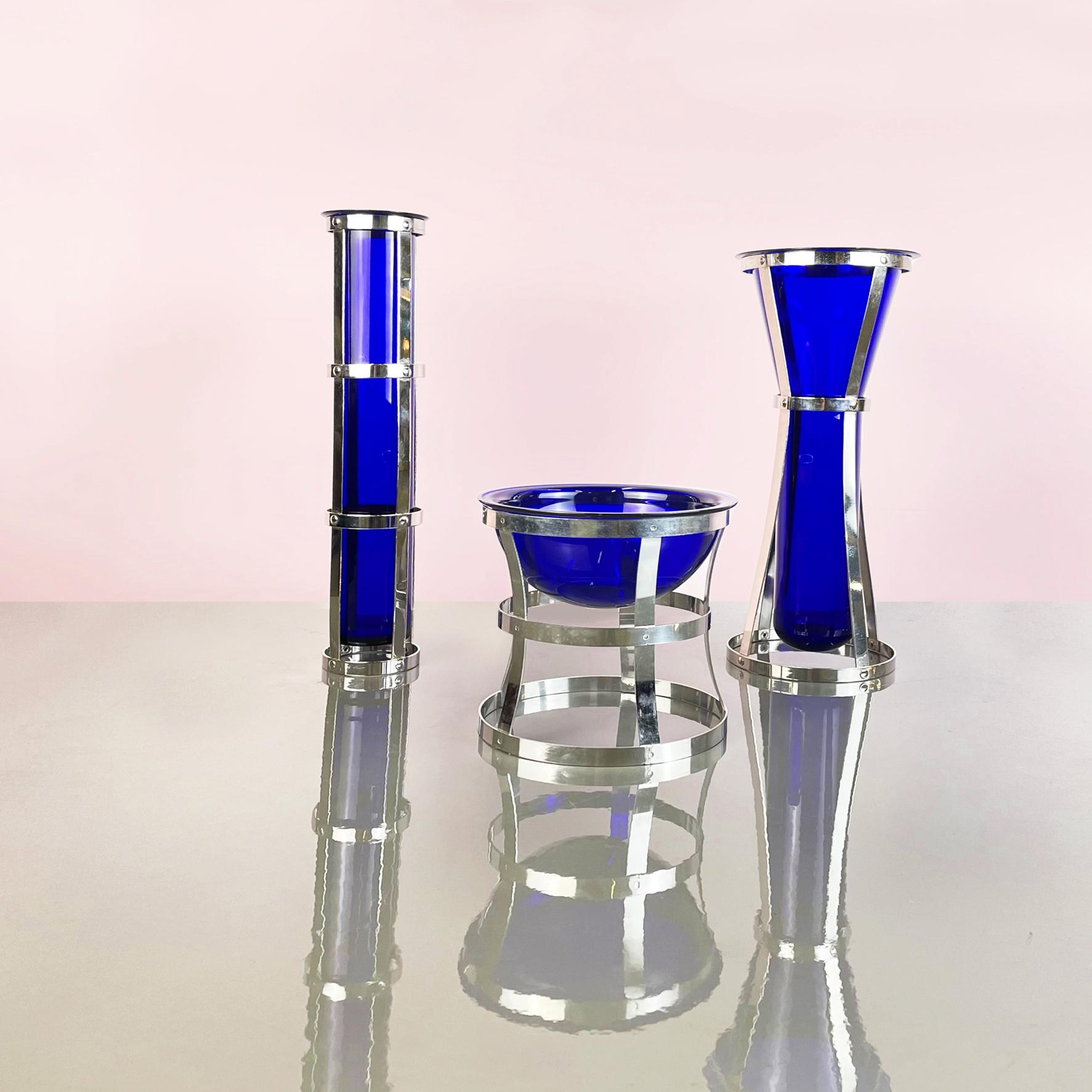 Italian Postmodern Blue Murano glass and metal Vases mod. Umeda by Cleto Munari, 2000s
Set of three vases mod. Umeda in blue Murano glass, resting on the metal structure that follows the shape of the vase. The three vases have different shapes: the
