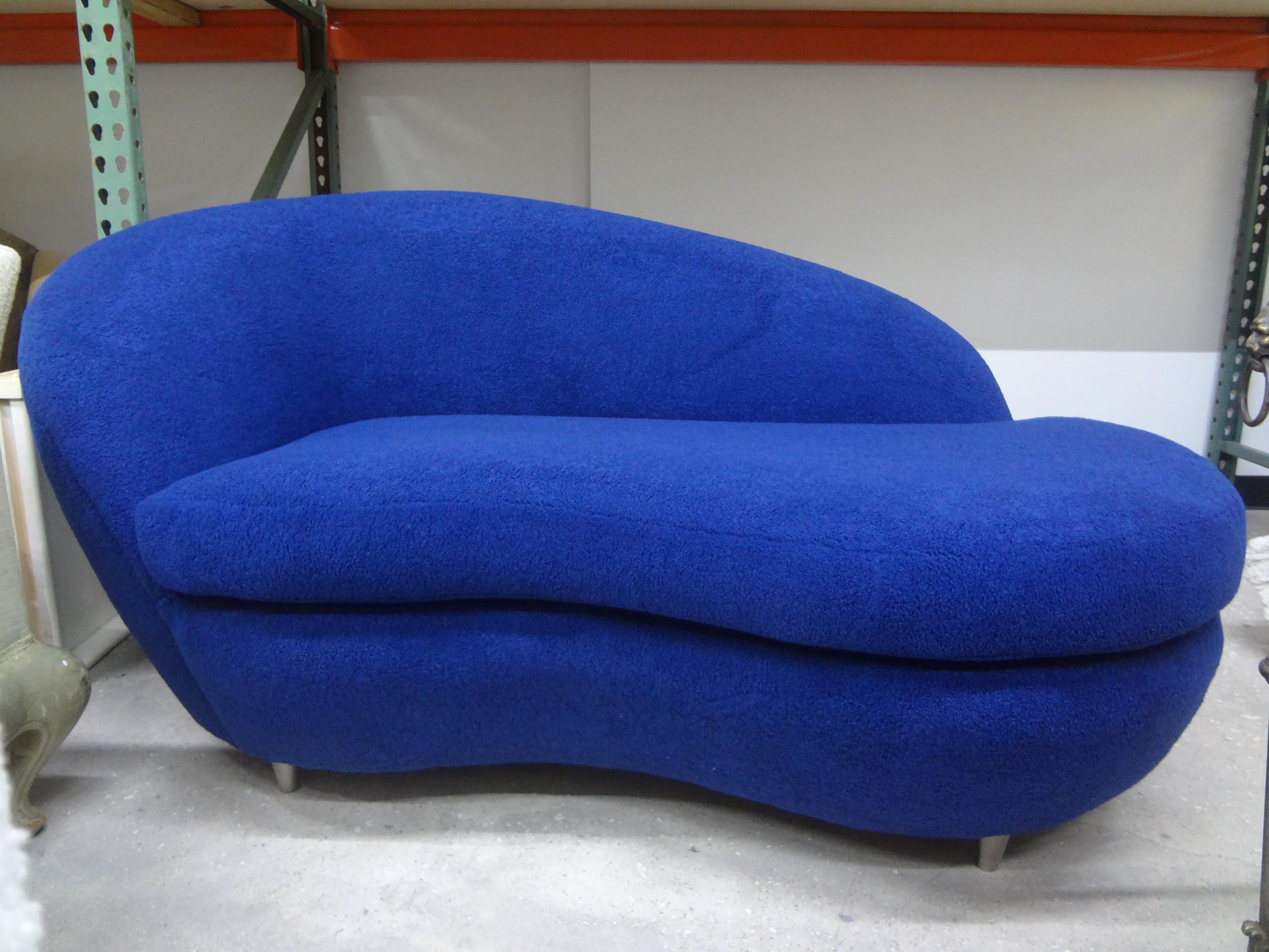 Italian postmodern curved sculptural loveseat or sofa. This stunning Italian Federico Munari inspired sofa, chaise or loveseat has interesting cone shaped stainless steel legs and has been professionally upholstered in plush sapphire blue bouclé