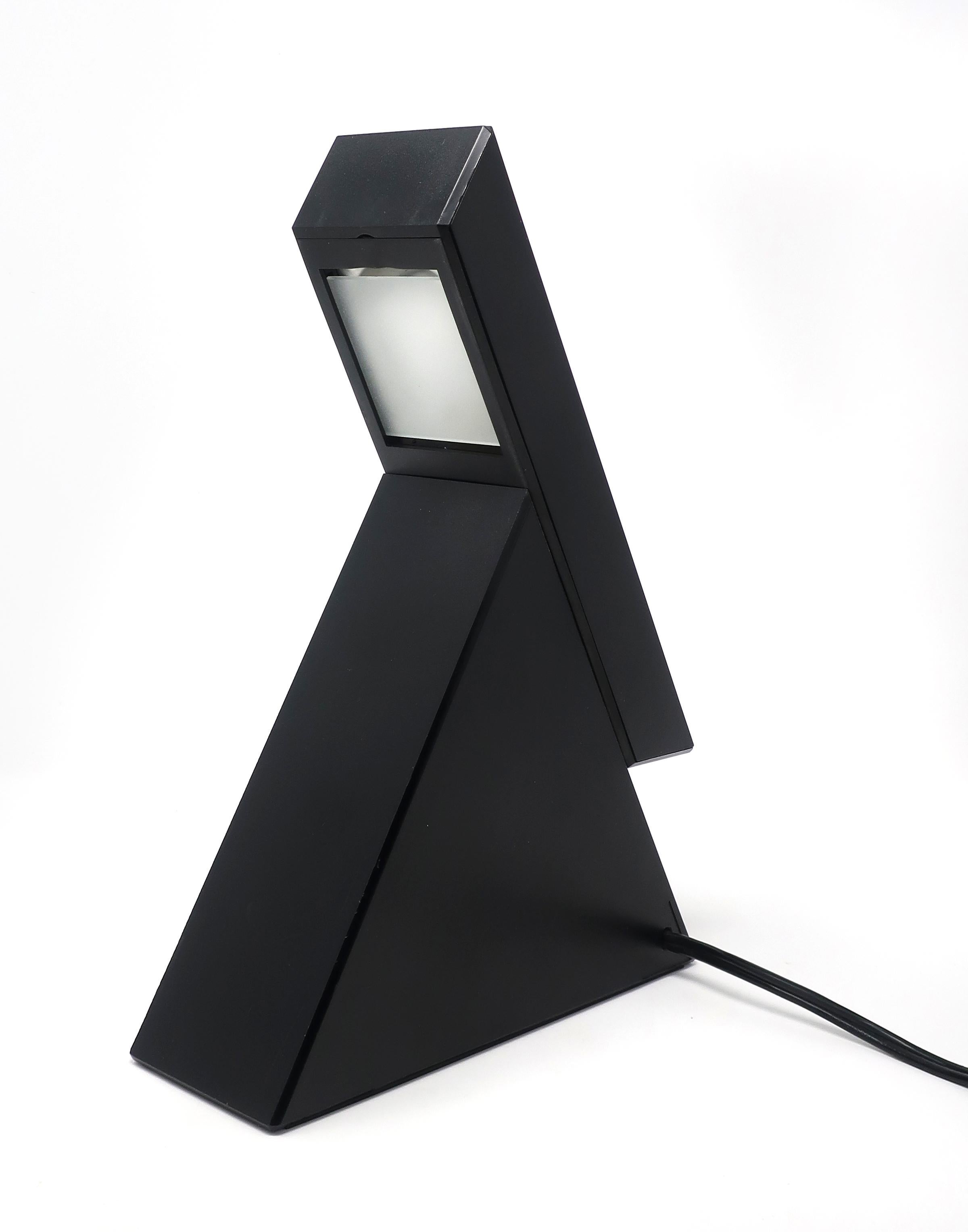 A geometric Postmodern table lamp designed by Mario Bertorelle for JM RDM Massanzago Italy. Lamp turns on by sliding the switch up to expose the bulb. It has 2 intensities, one low and one brighter when the cantilevered slide is extended all the