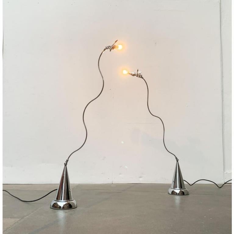 Filigree floor lamps from the Italian manufacturer Disegnoluce according to a design by Andrea Bastianello. A postmodern design with striking shapes. The finely executed shaft of the luminaire shows a uniform waveform. The foot forms a sharp cone
