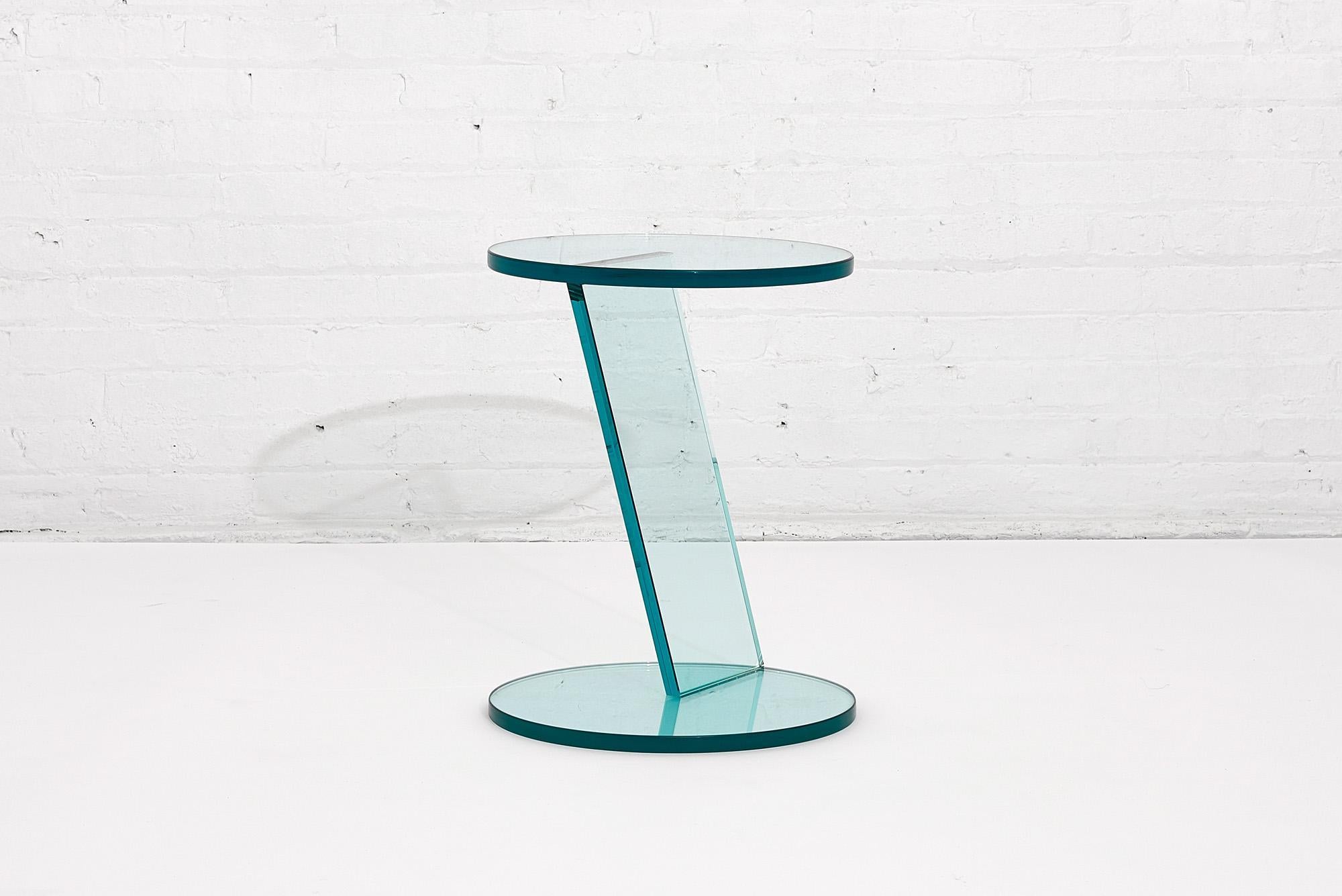 Italian Postmodern glass drink table. A Postmodern style round all glass table with asymmetric design, Italy, circa 1990s.