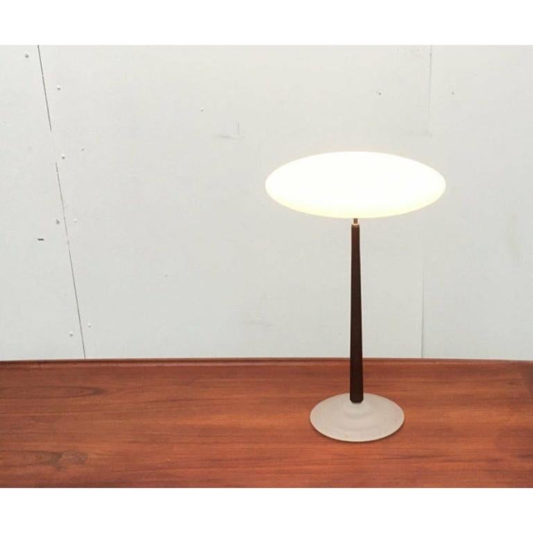The large T2 table lamp version from the Pao lamp series by Matteo Thun.

The Pao lights impress with their characteristic diffuser made of frosted glass. What is particularly special, however, is the material combination of glass and wood that