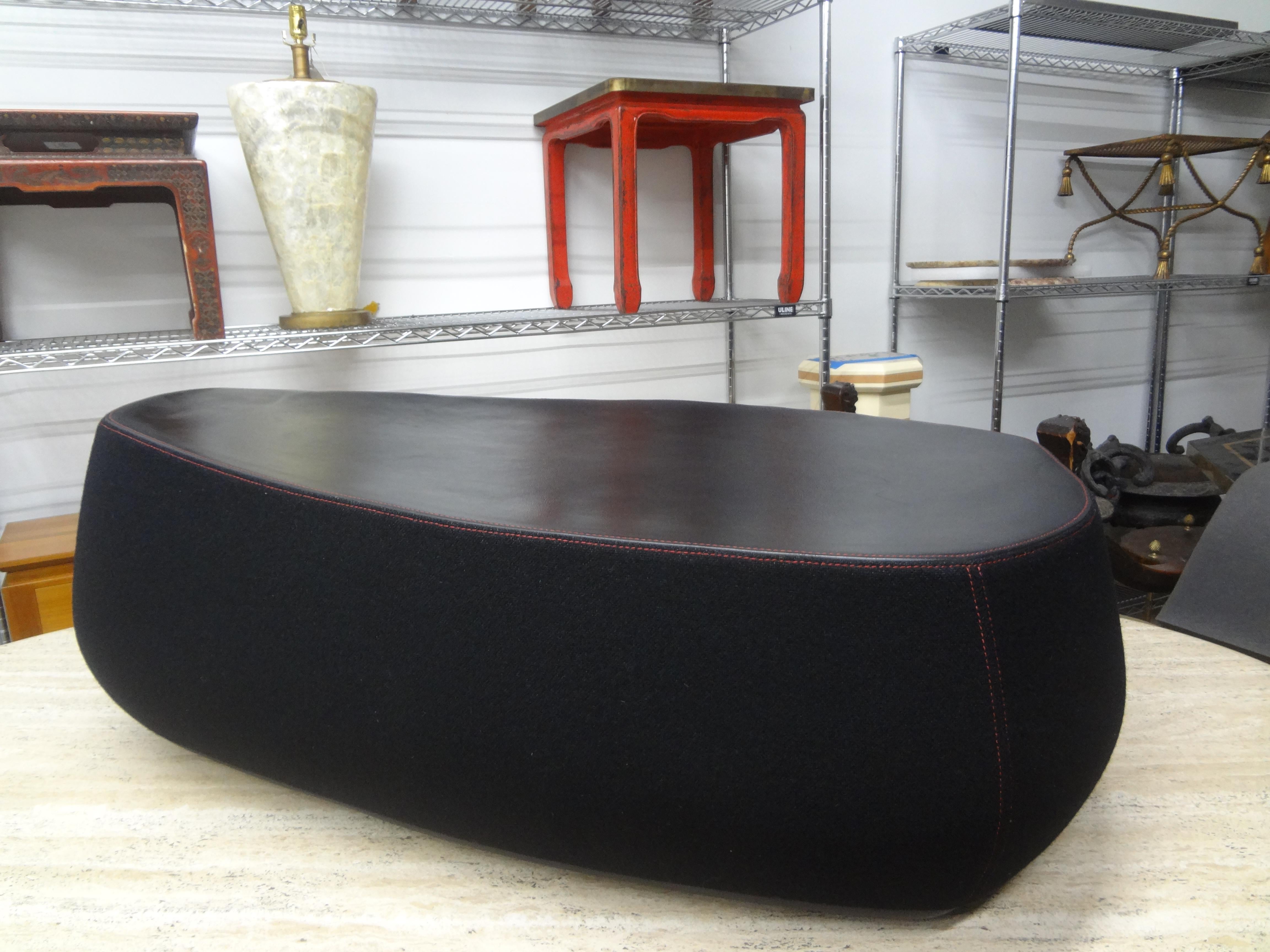 Italian Modern Sculptural Bench Or Pouf By Moroso.
This chic Italian sculptural bench retains the original black wool type fabric with red stitching and a leather top. Large enough to seat two and stunning floating in a room!