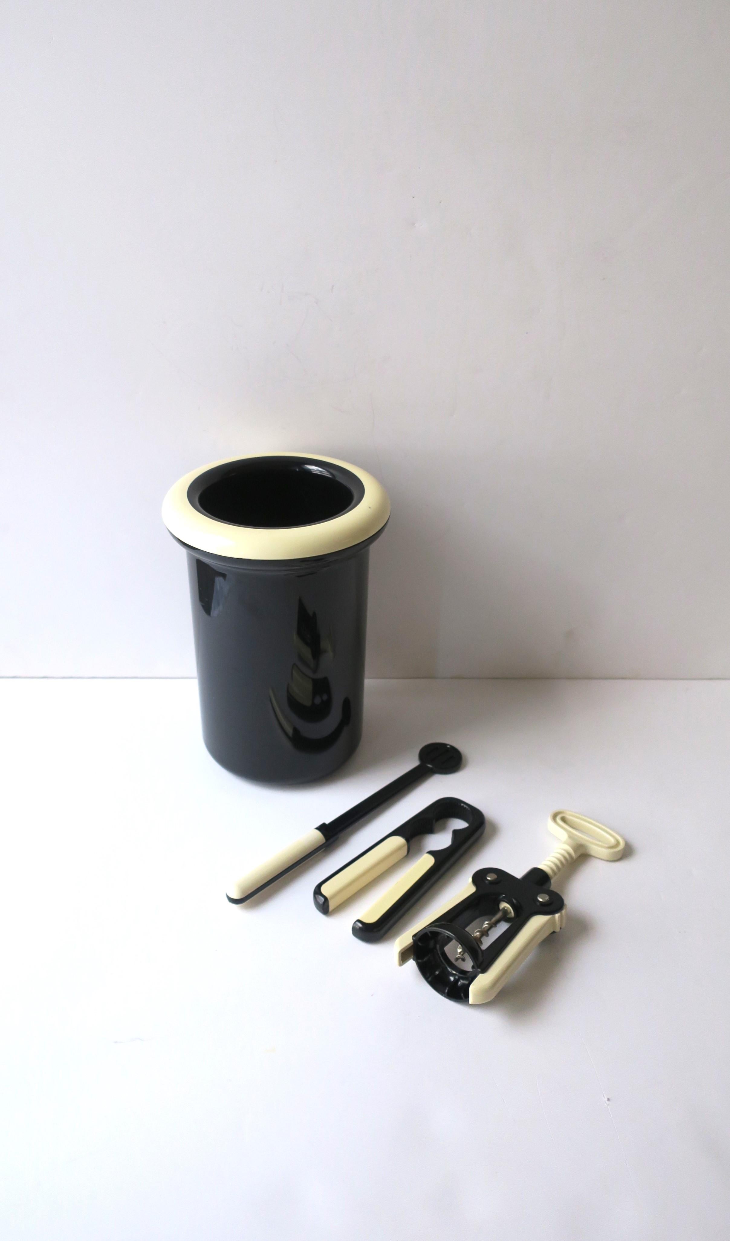 An Italian Postmodern black and white wine or Champagne cooler or ice bucket and bar tool set, circa late-20th century, 1980s, Italy. Set is four (4) pieces and includes wine or Champagne cooler or ice bucket, wine bottle opener, Champagne cork grip