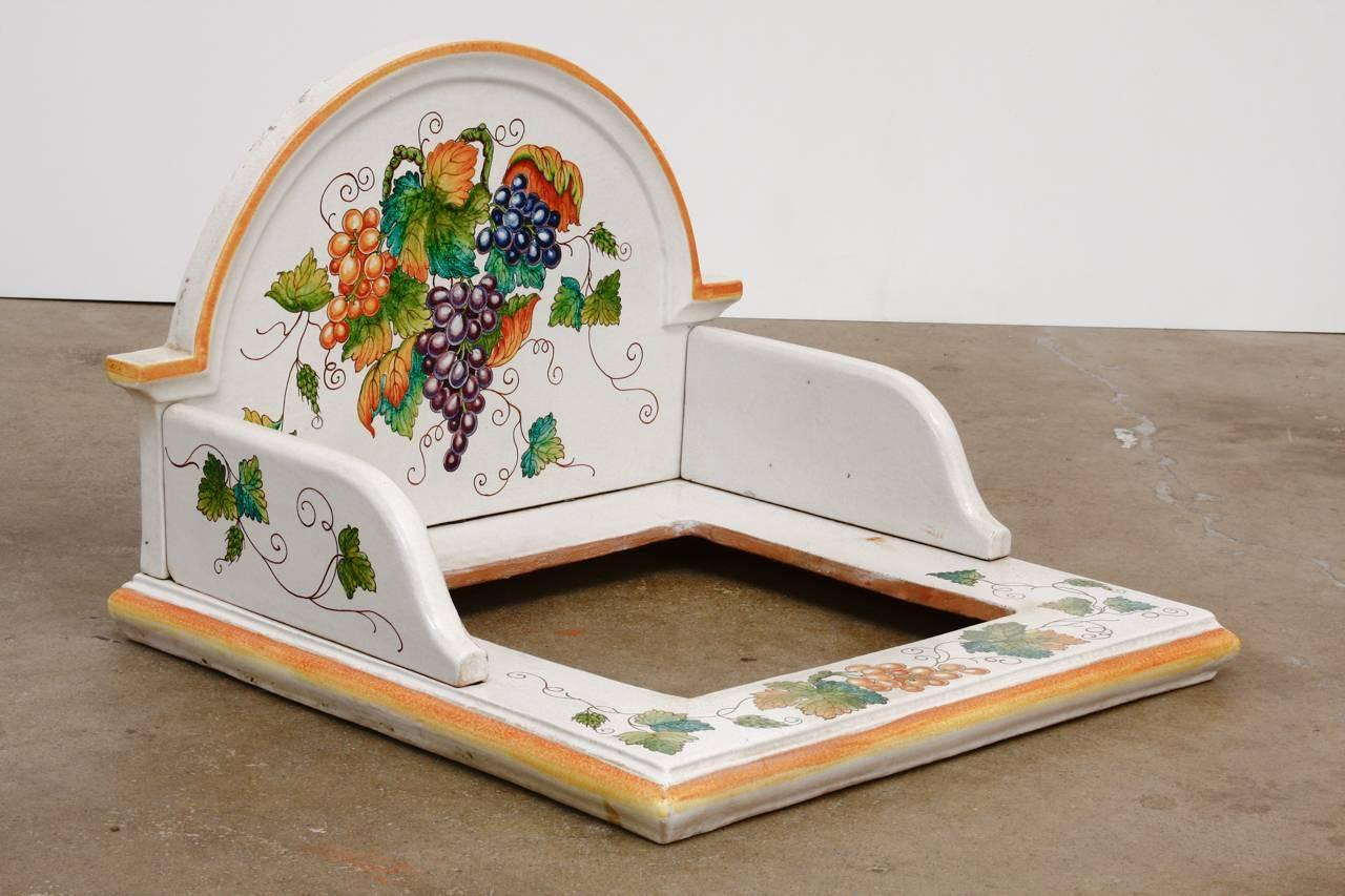 Unusual hand-painted Italian pottery ceramic hibachi or garden sink surround. Features an arched wash stand style backing made of three parts and a base with a 14