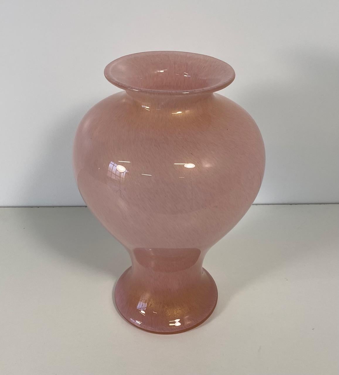 This vase was produced in Italy, more precisely in Murano, Venice by Barovier & Toso, which is an Italian company that specializes in Venetian glass. 
The vase is in powder pink submerged glass with gold leaf inclusion and is part of the 'Tepore'