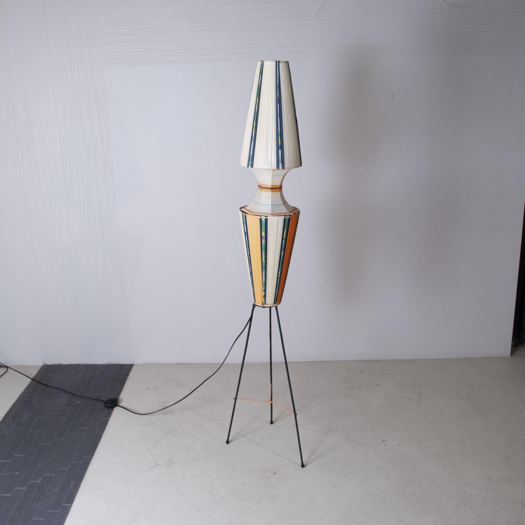 Typical floor lamp produced in Italy late 1950s black lacquered metal structure illuminating part in plastic fabric of various colors typical of the time.