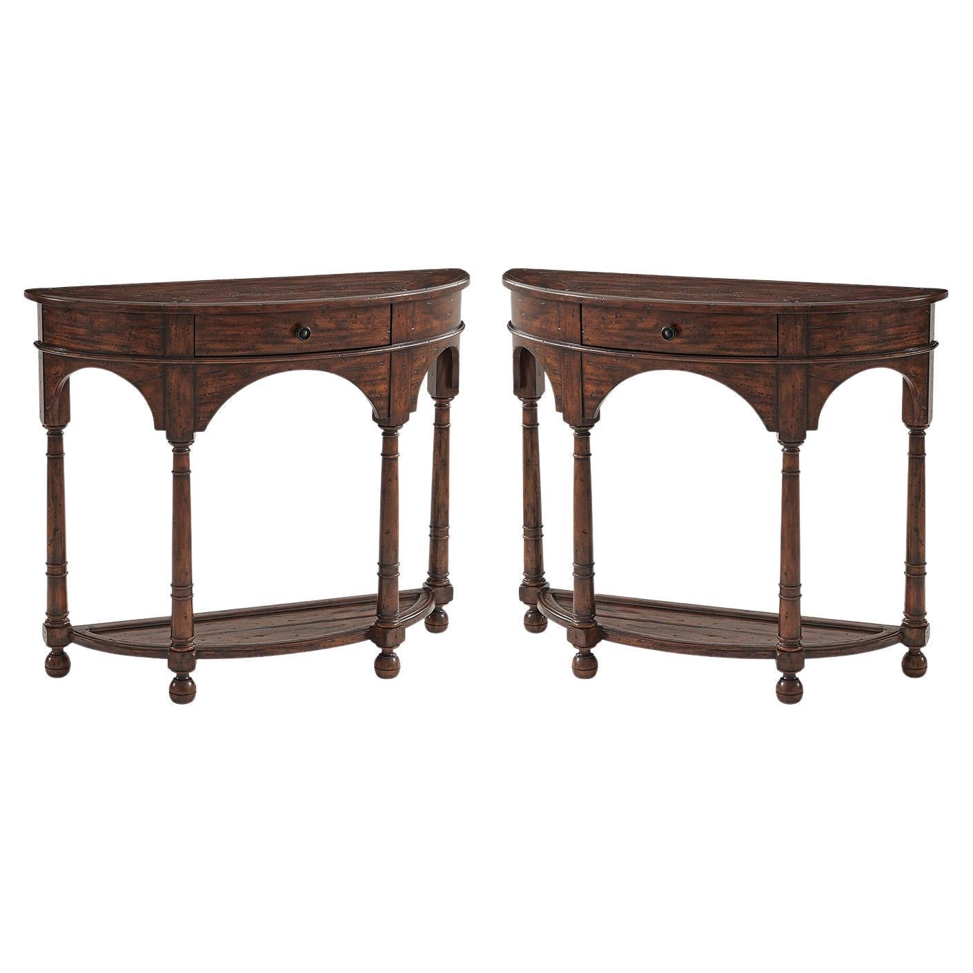 An Italian Provincial antiqued wood bowfront console table, the bowed frieze drawer above arched aprons, turned supports and feet, joined by an under tier. 

Dimensions: 44