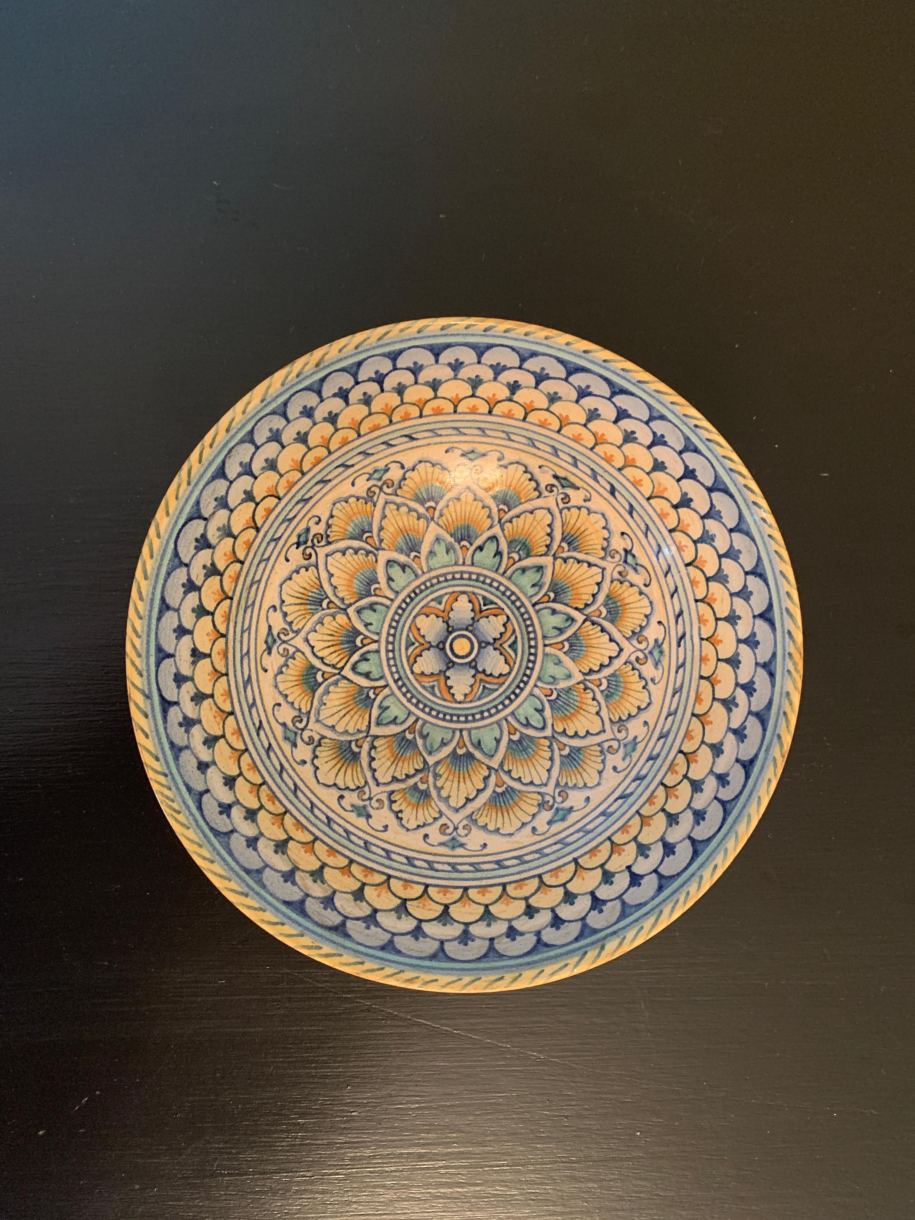 A beautiful hand painted blue, cream, and yellow faience pottery bowl featuring geometric designs.

By Cynthia Deruta

Italy, Late-20th Century

Measures: 5.75