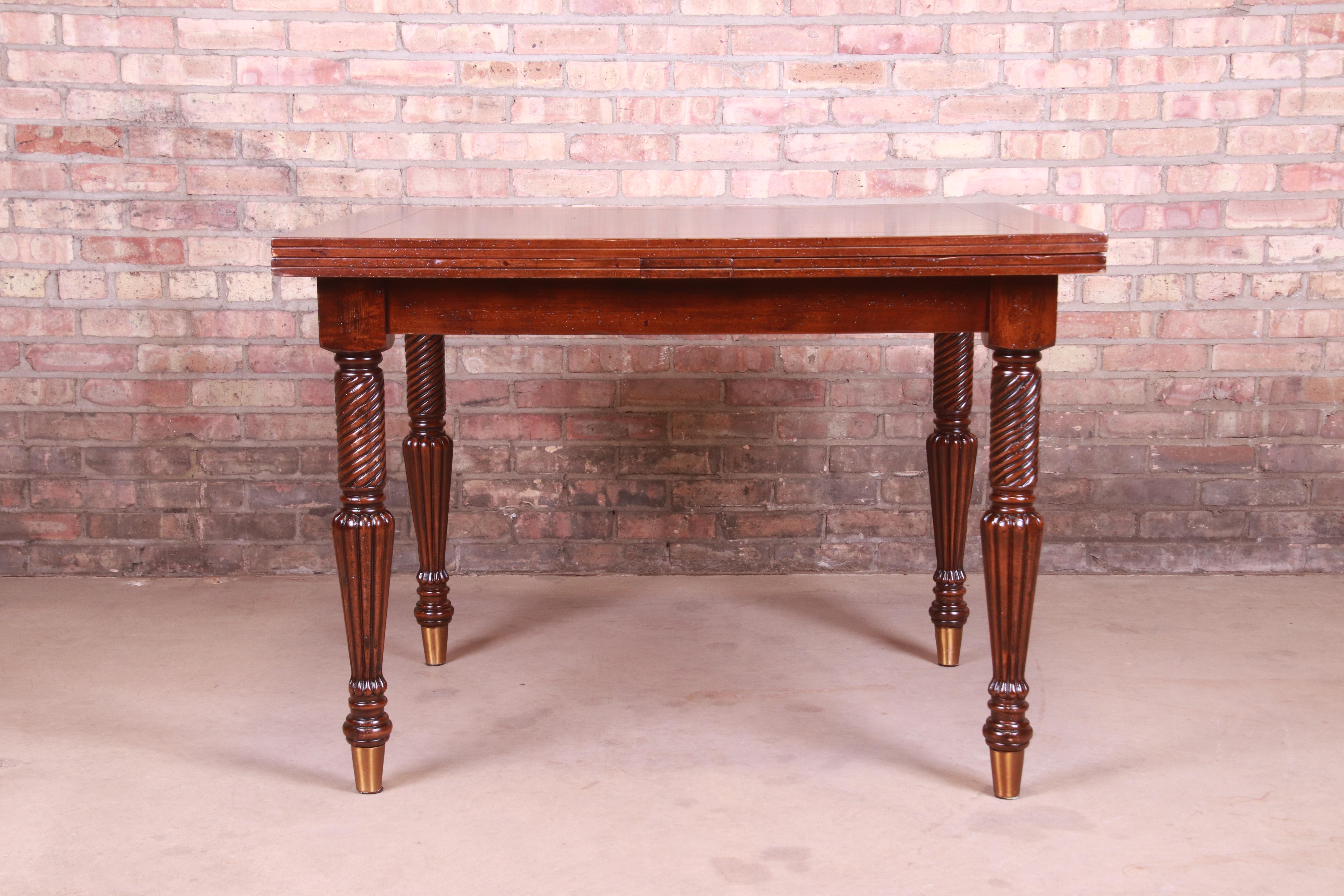 A gorgeous Italian Provincial extension dining table with turned legs

By Guido Zichele

Retailed by Bloomingdale's, New York

Italy, late 20th century

Walnut, with turned legs and brass sabots.

Measures: 42.5