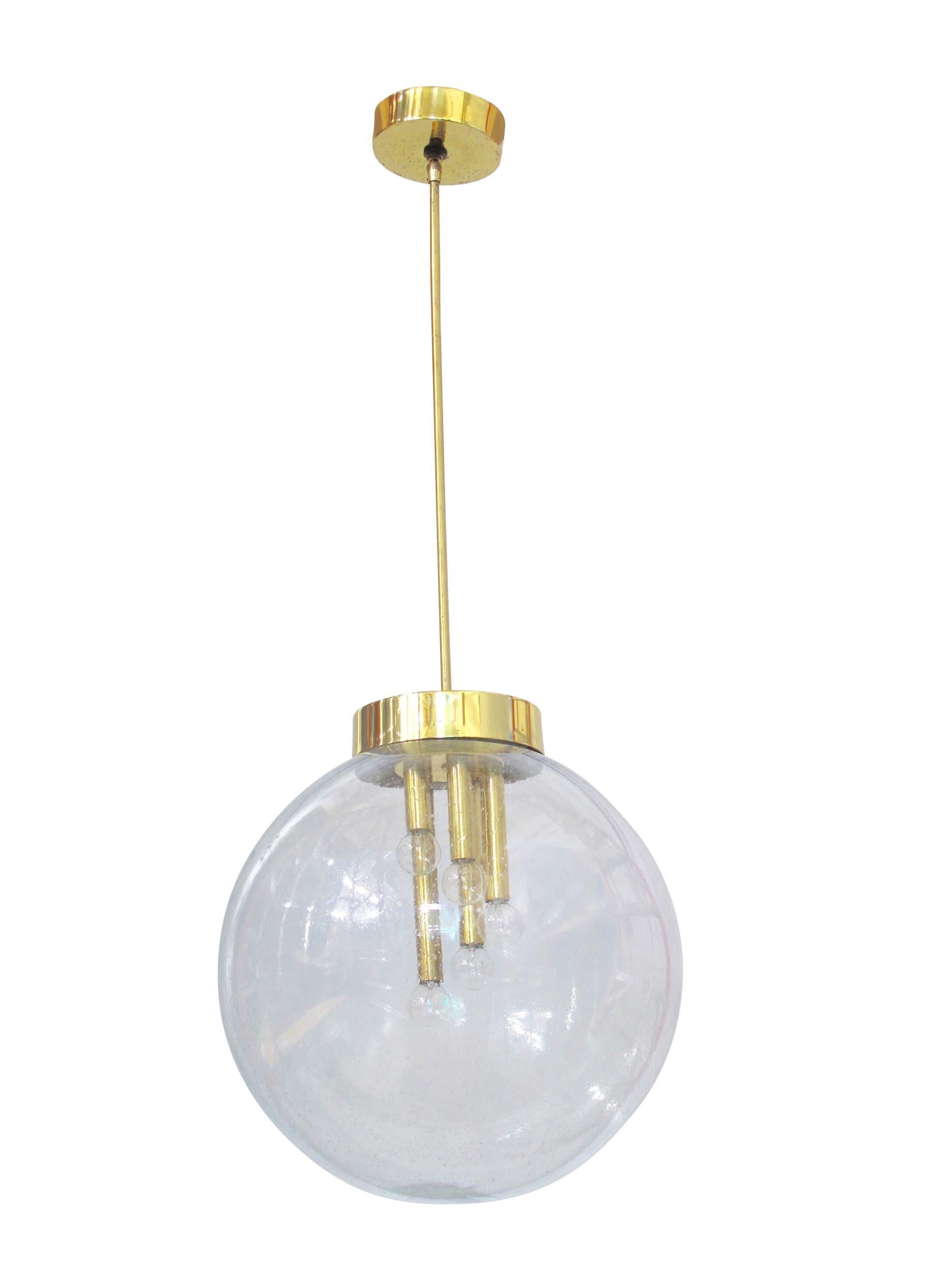 Mid Century Italian glass pendant chandeliers crafted of hand-blown Pulegoso glass with five lights per unit, suspended on brass stem and canopy. 15