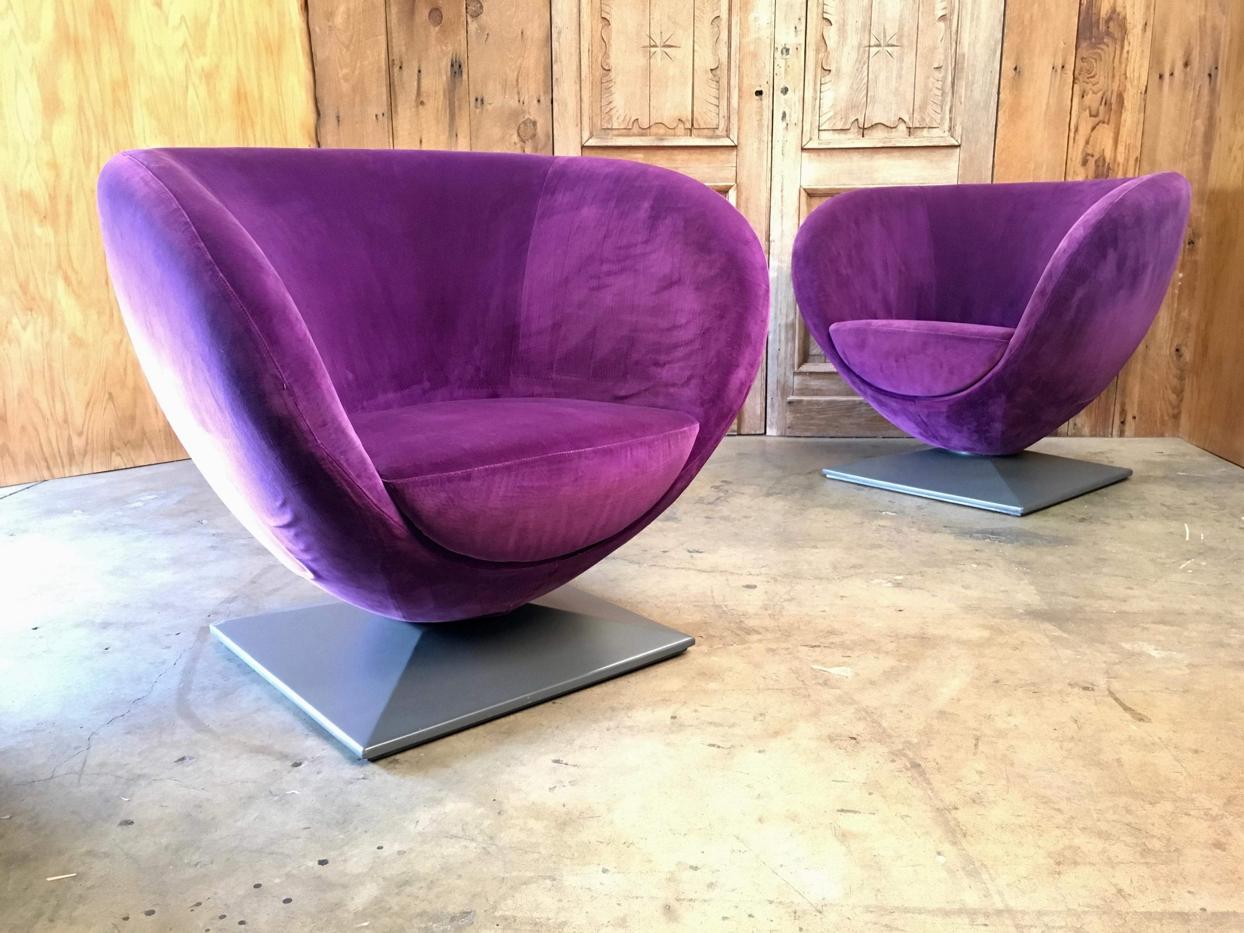 1980s Pod chairs that tilt and swivel in plum crazy velvet on grey painted pyramid bases.
