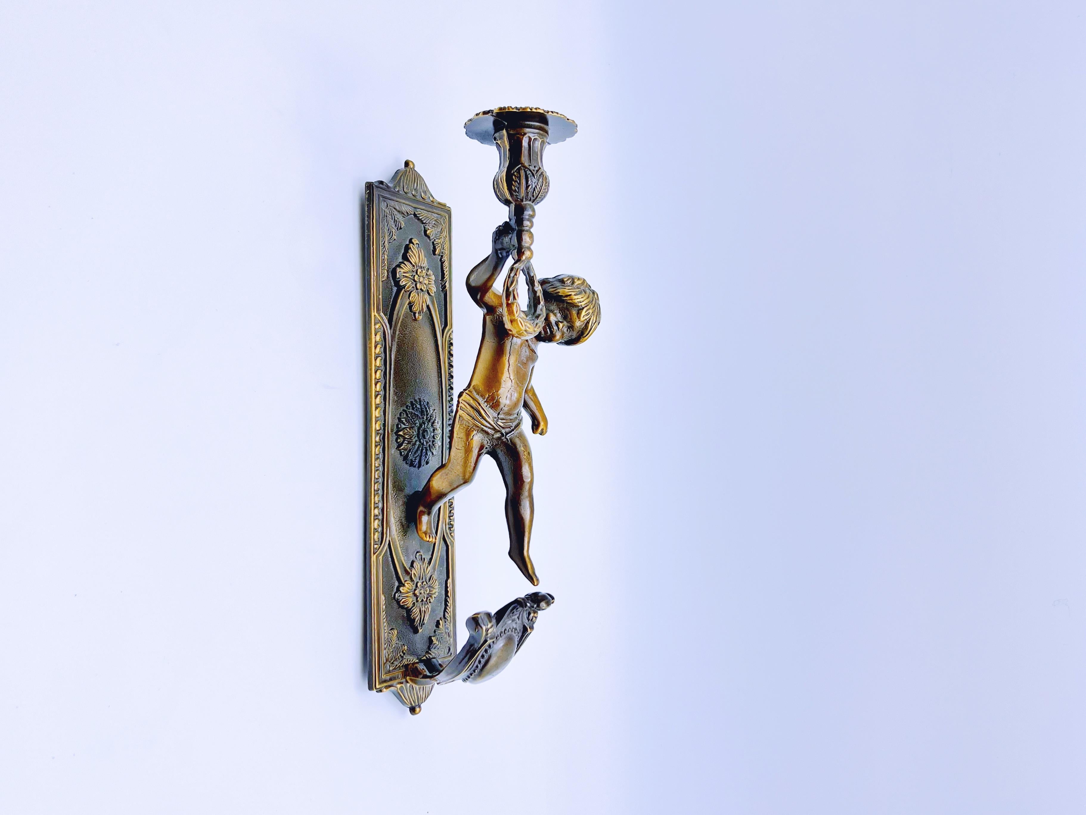 Stunning vintage brass/bronze Putti Cherub Angel wall-mounted candleholder/wall light/sconce/candlestick from the second half of the 20th century. Made in Italy.

Condition: Very good vintage condition, with minor age-related wear and patina.

Solid